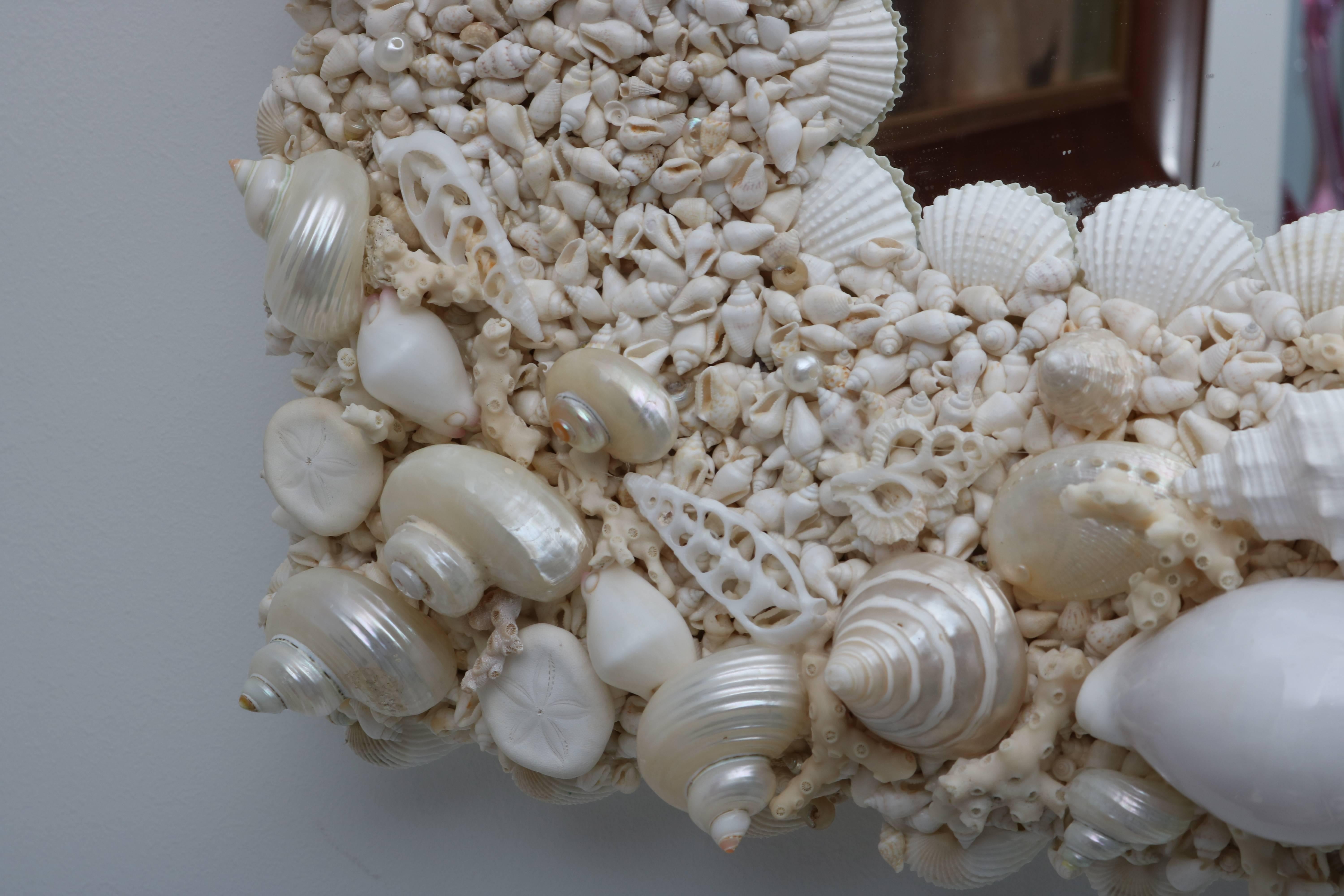 Tony Duquette Style Sea Shell Encrusted Mirror in White and Pearlized Coloration In Excellent Condition In West Palm Beach, FL