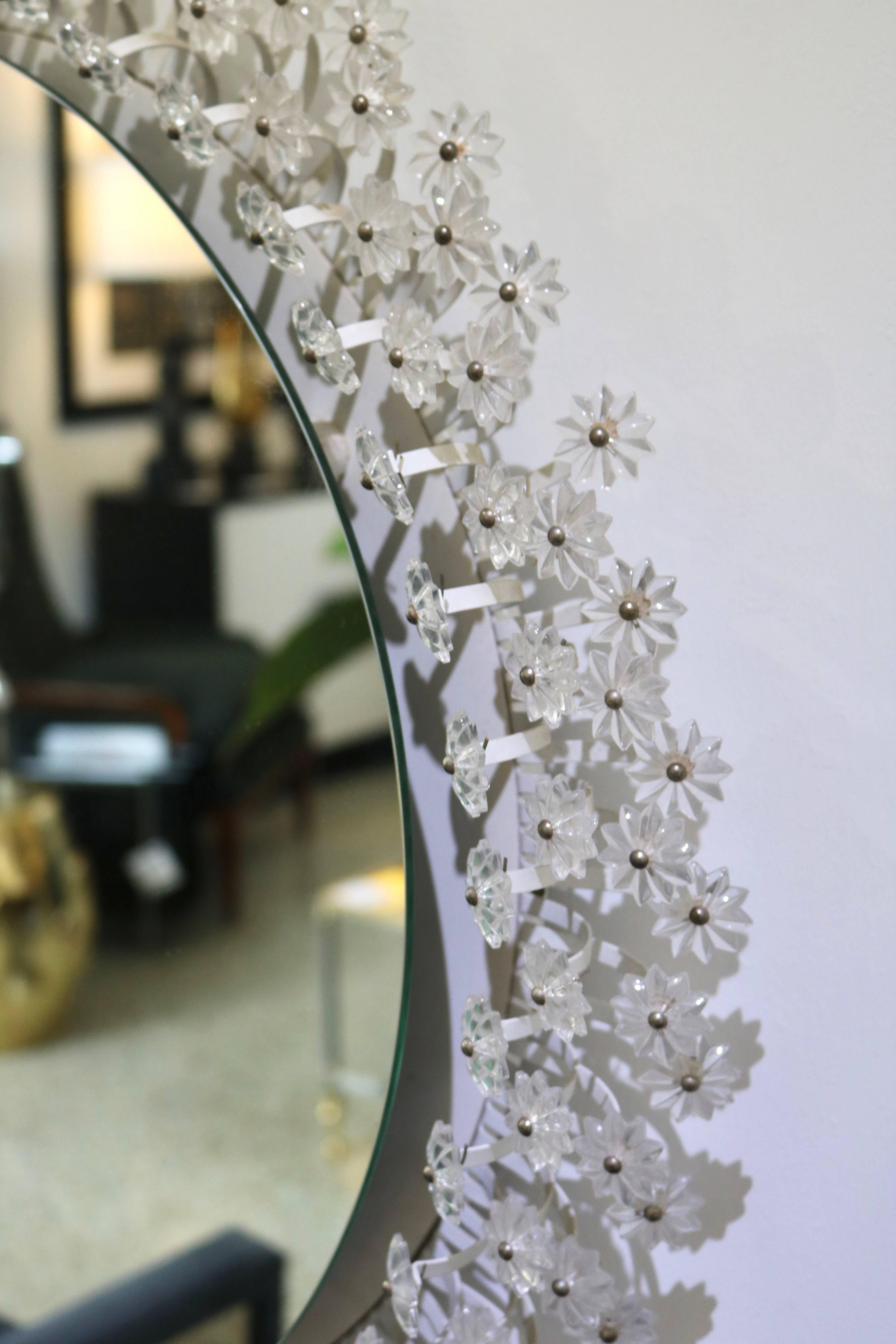 This stylish wall mirror dates from the 1970s and will make the perfect dressing mirror or perhaps and entry hall. The stars used for the border are fabricated in lucite.

The piece has been professionally rewired with L.E.D. bulbs.

For best