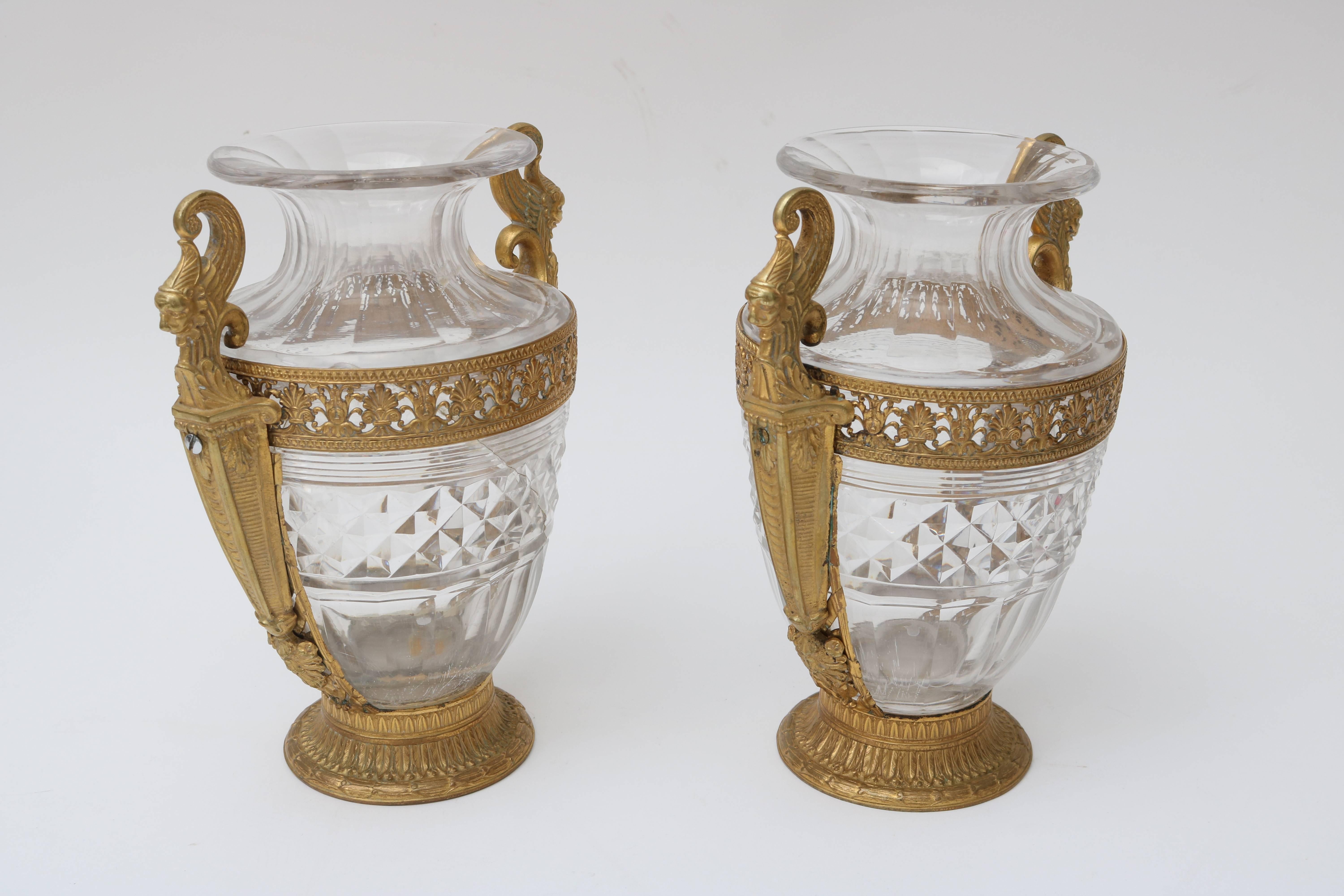 This pair of French Empire vases date from the 19th century and are of exceptional quality. Unfortunately one of the cut crystal vase has been cracked but does not detract from its overall beauty.

