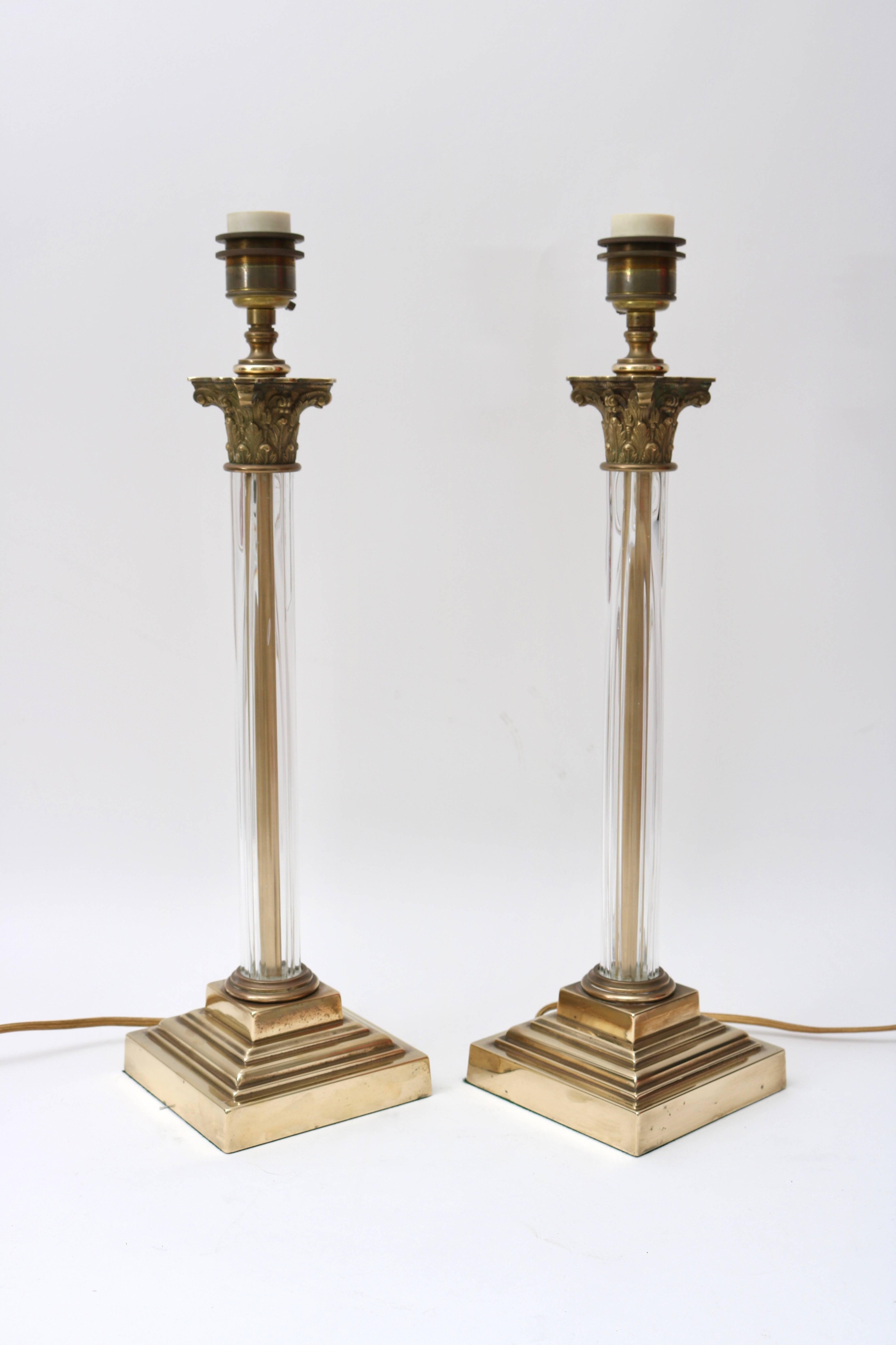 This pair of bronze column-form, Corinthian capital table lamps have recently been restored with new wiring and polishing. 

