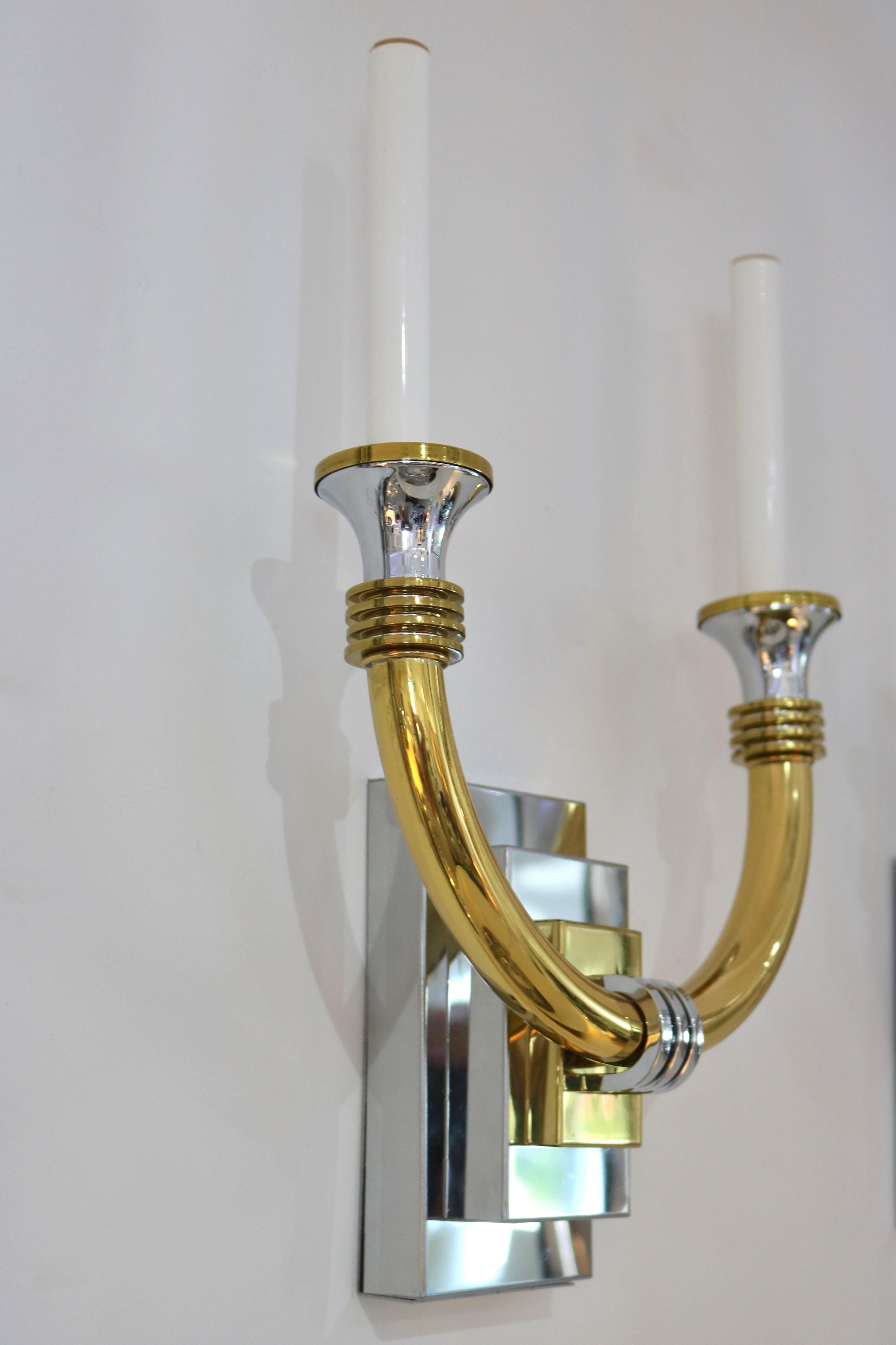 This handsome pair of wall sconces have taken the inspiration for the glamour of the Art Deco period and pieces that were produced in the 1980s. They are in polished chrome and brass and were produced in Italy.

Note: The lead photo shows flecks on