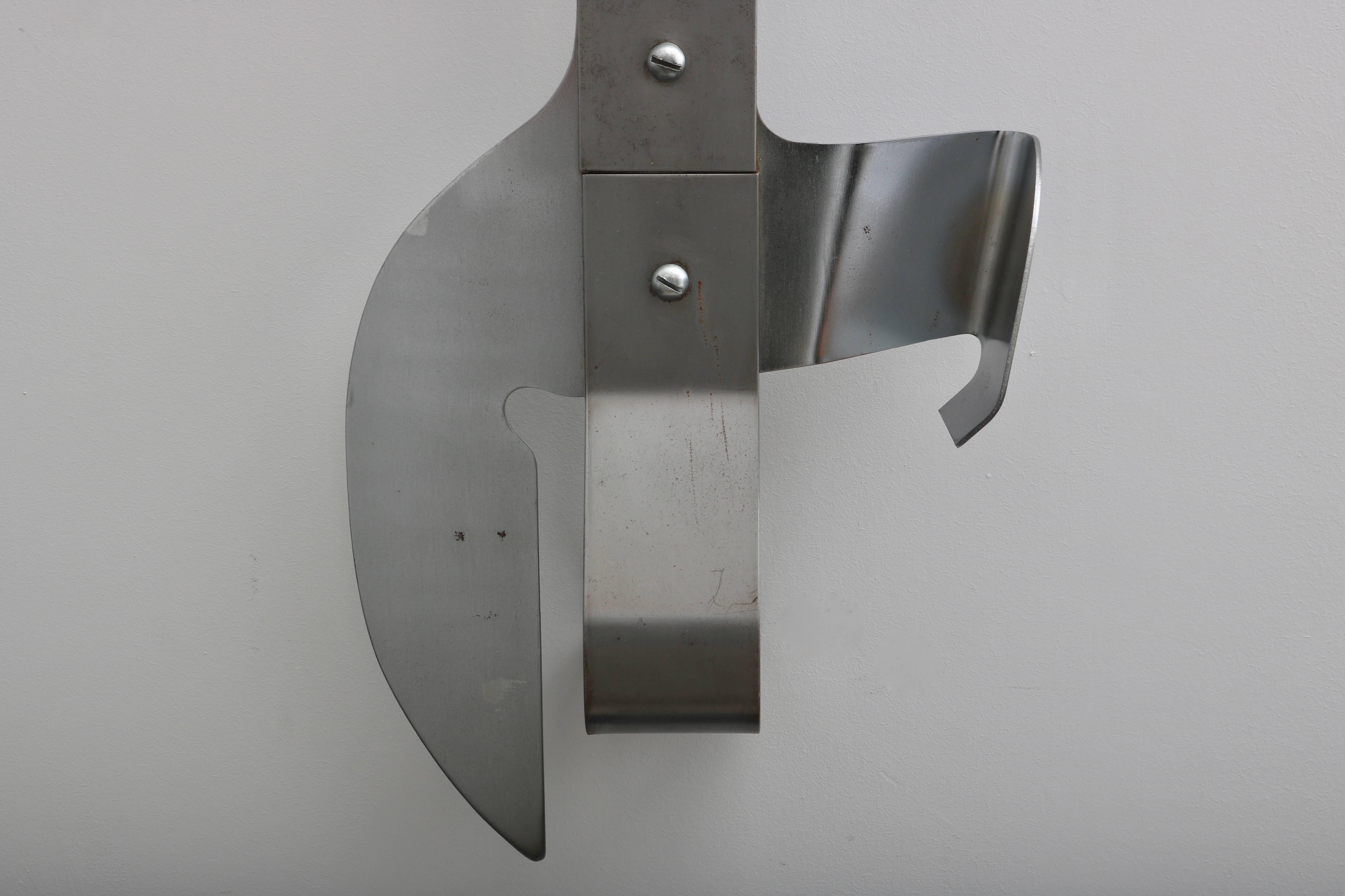 This large-scale wall Curtis Jere wall sculpture of a cork-screw, can opener was created sometime in late 1960s to the late 1970s and is fabricated in stainless steel.


 