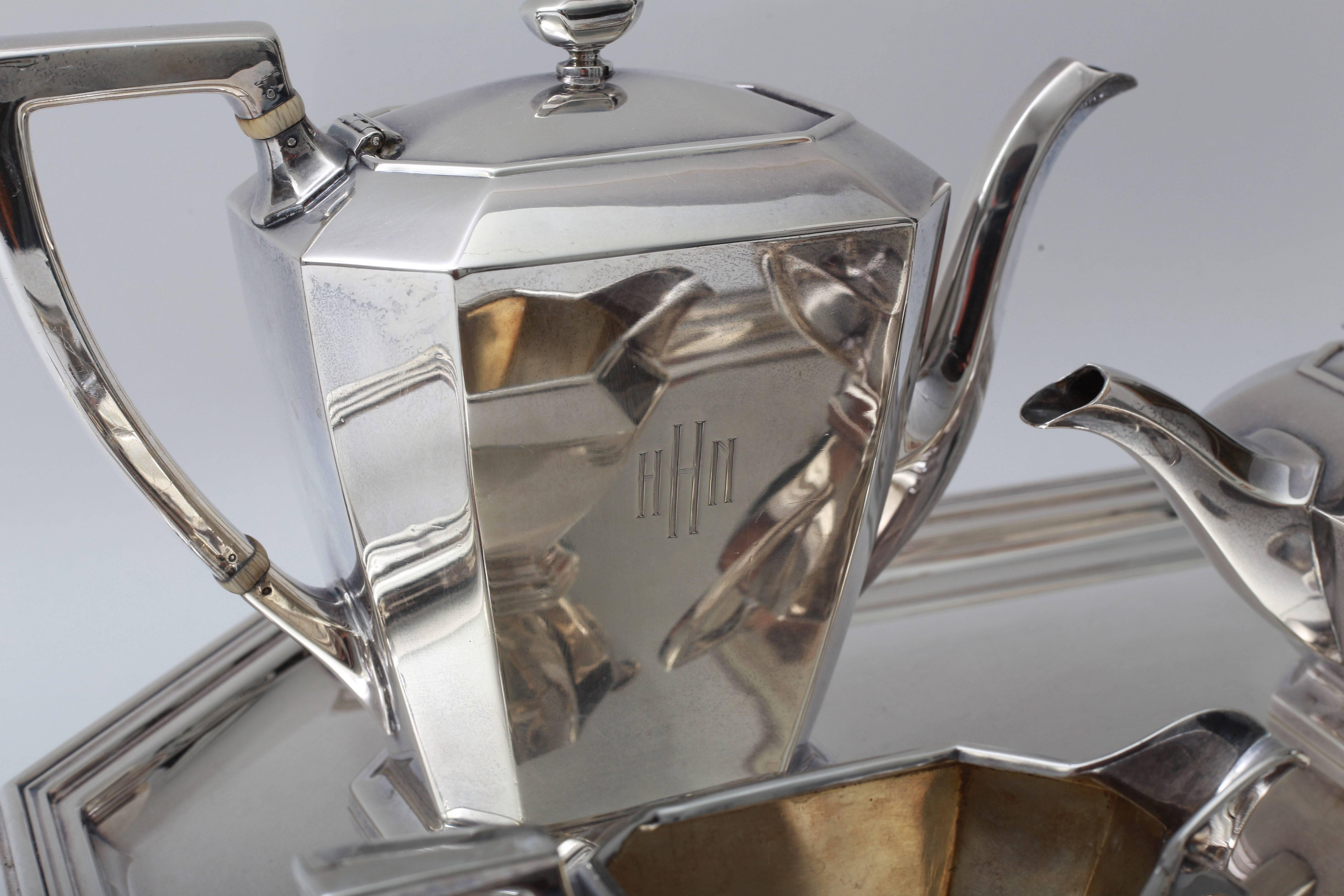 This stylish Art Deco period coffee service dates to the 1920s-1930s and was retailed by Black Star and Frost jewelers. The creamer, sugar, coffee and tea pieces are sterling silver and the tray is silver plated. 

Note: The Black Star & Frost