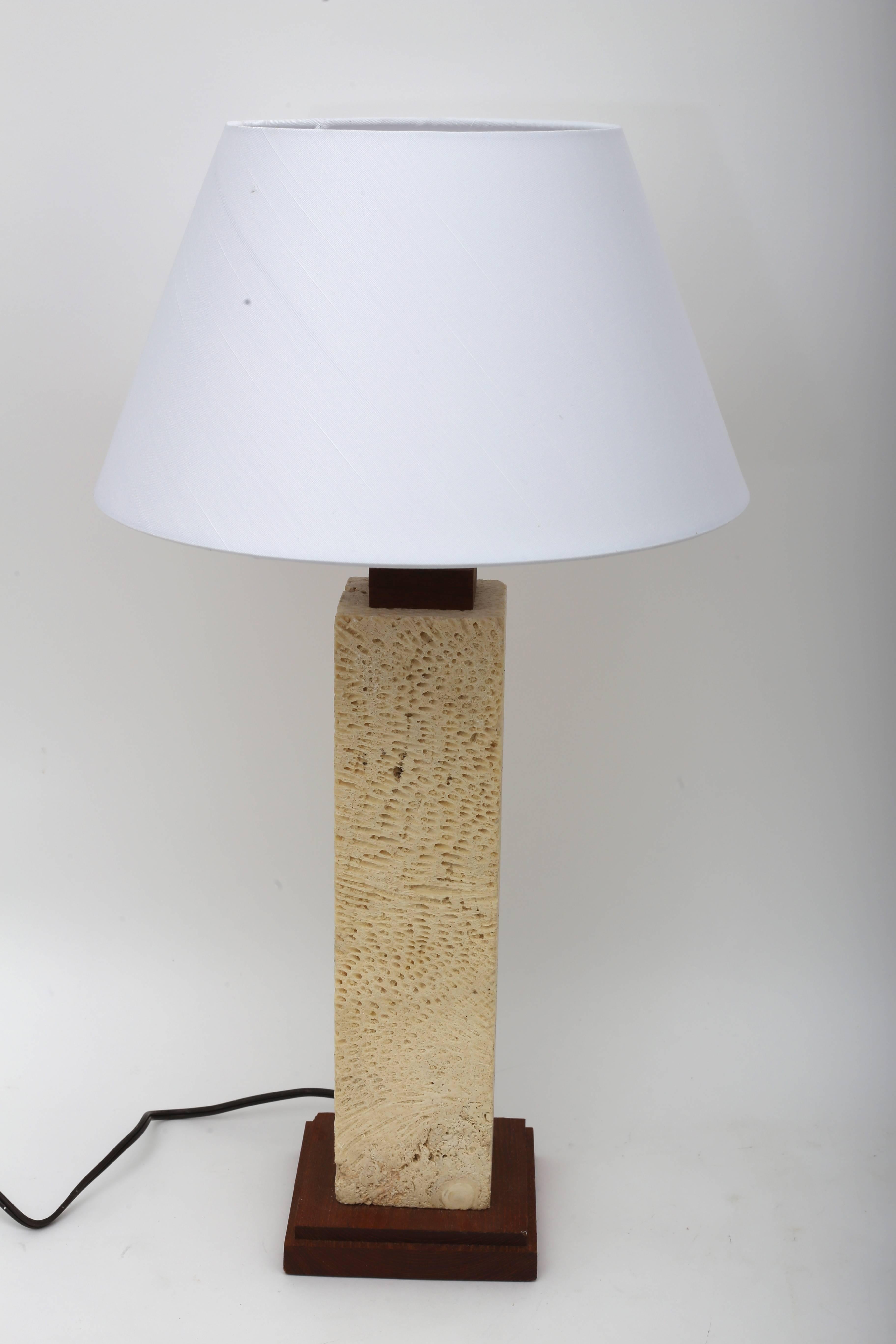 This stylish pair of table lamps are fabricated from a single piece of coquina stone and a teak base.

Note: Dimension to top of socket is 16.50