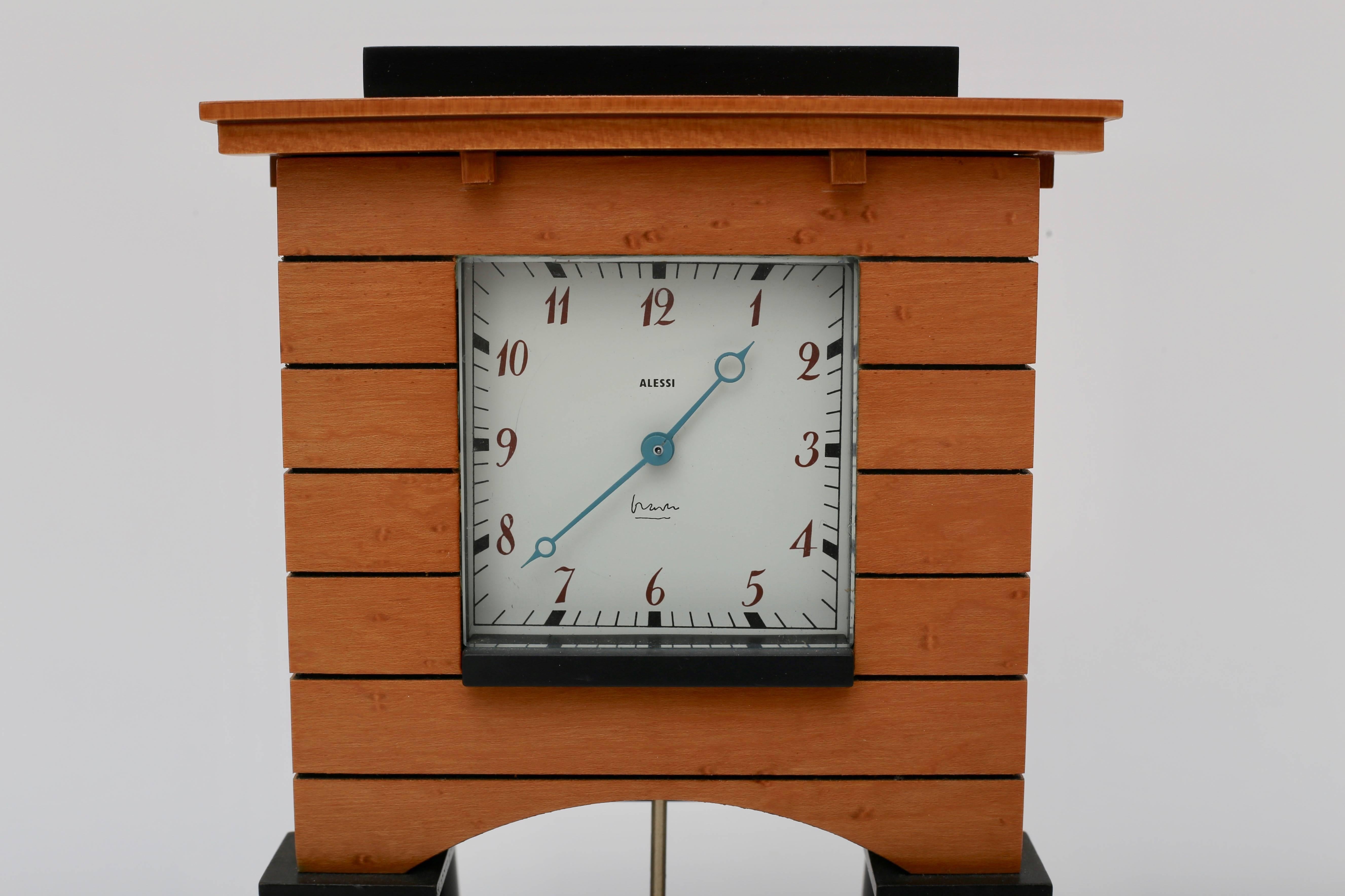This stylish Postmodern mantel clock was designed in 1986 by Michael Graves for Alessi, Michael Graves designs are iconic and classic with his use of line and materials.

Note: Requires one AA battery.

Note: The top of the clock has a slight bow to