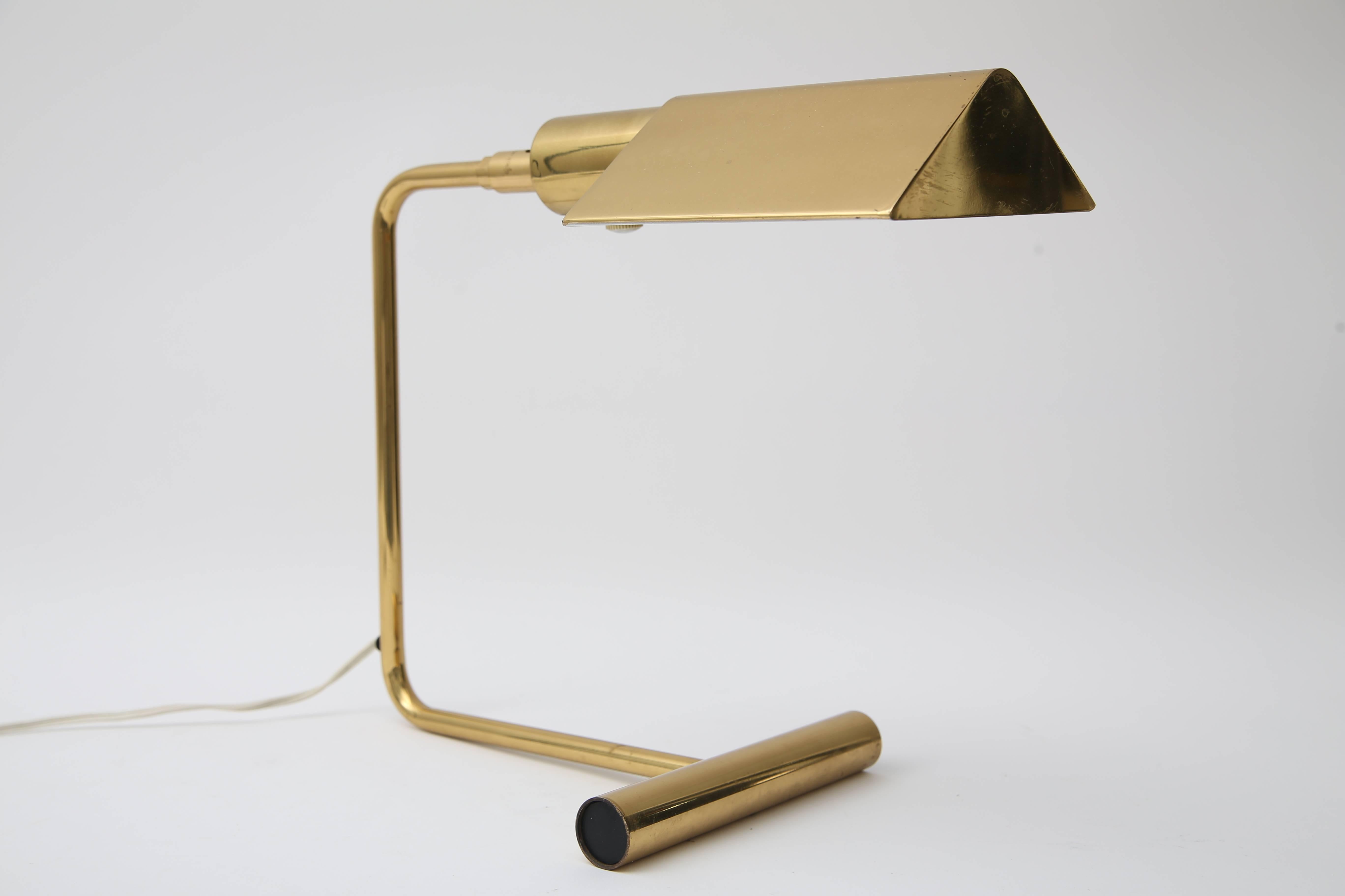 This stylish and rare-form table lamp was produced in the late 1970s-mid-1980s, by the iconic firm of Koch and Lowy. The classic pharmacy shade with a cantilevered form is still classic to this day.

