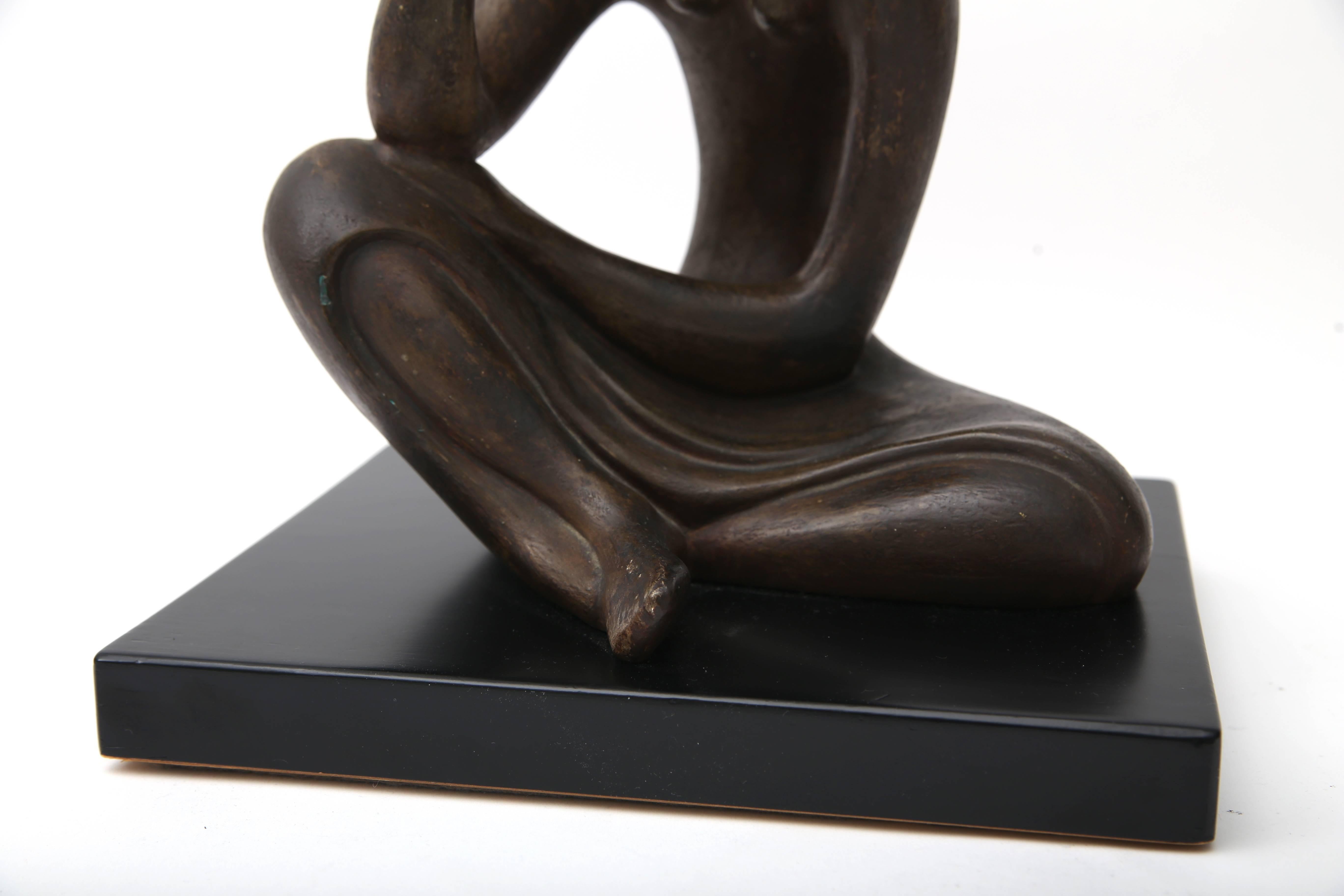 Molded  Sculpture of a Seated Female in Bronze Coloration
