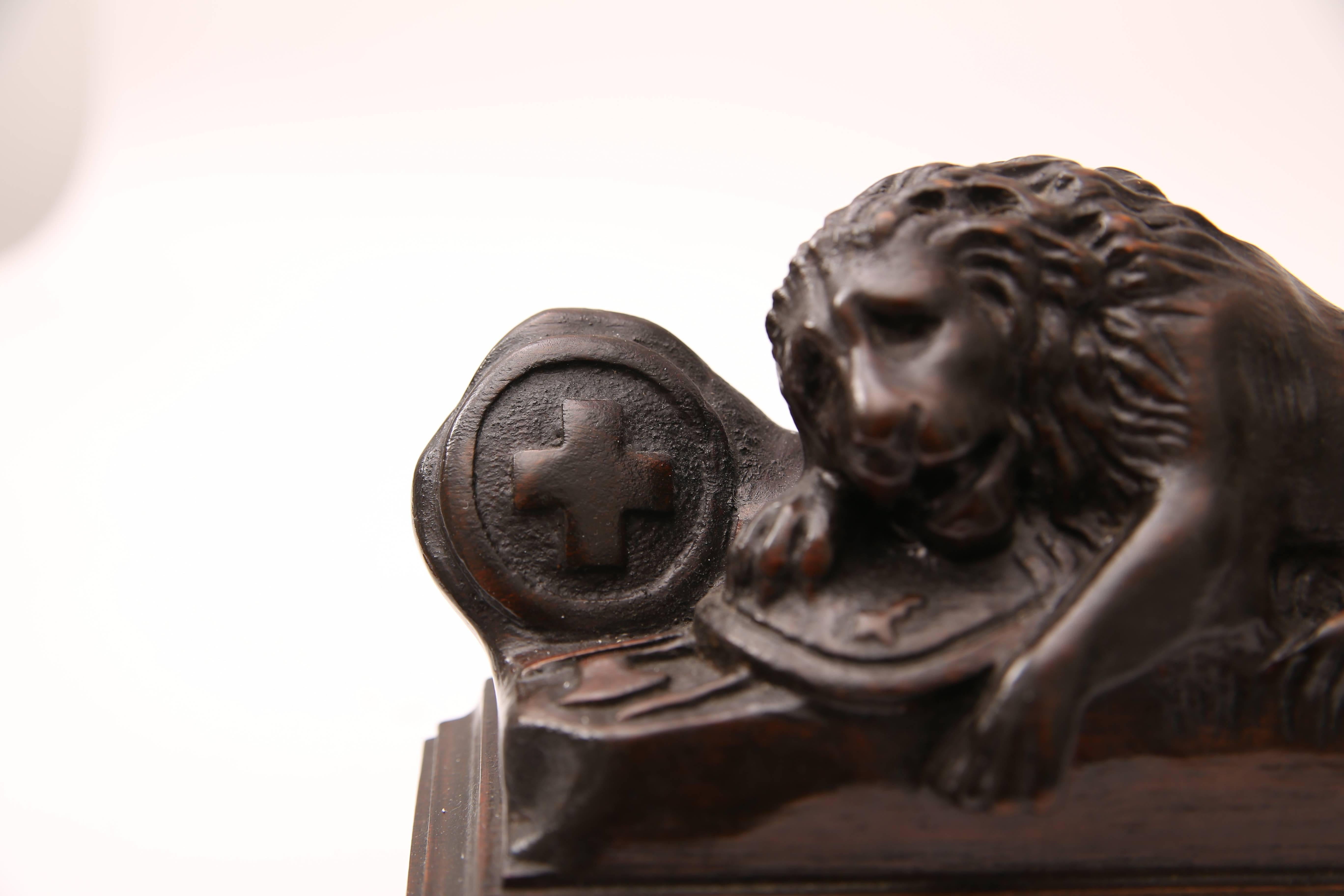 20th Century Pair of Carved Wood Book Ends Depicting the Swiss Guard Lions of Lucerne, France