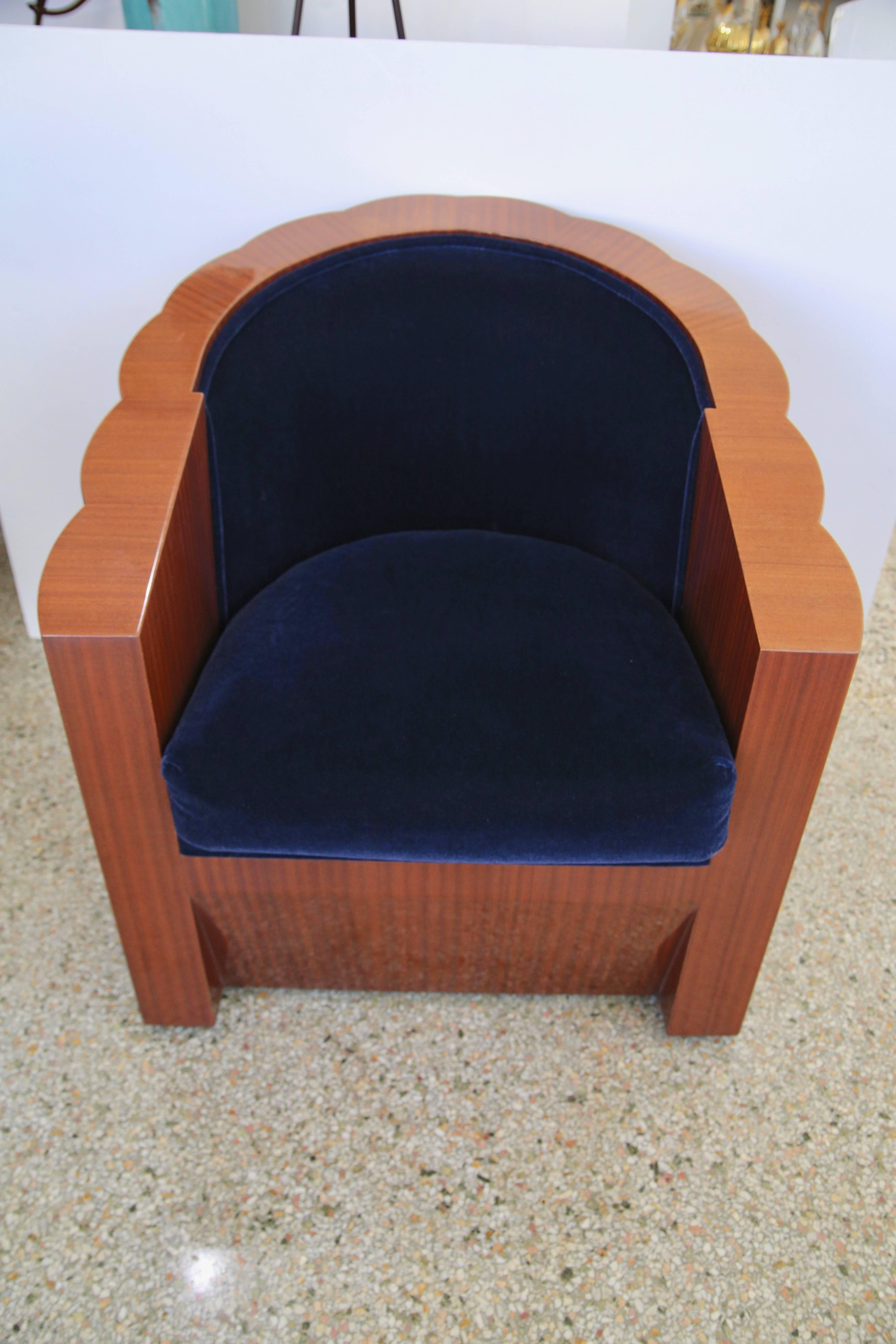 This large scale Art Deco inspired club chair will make a statement with its form and use of materials. The ribbon mahogany frames the deep blue mohair upholstery beautifully.  

Note: Seat cushion is removable.

Note: The piece is on casters and