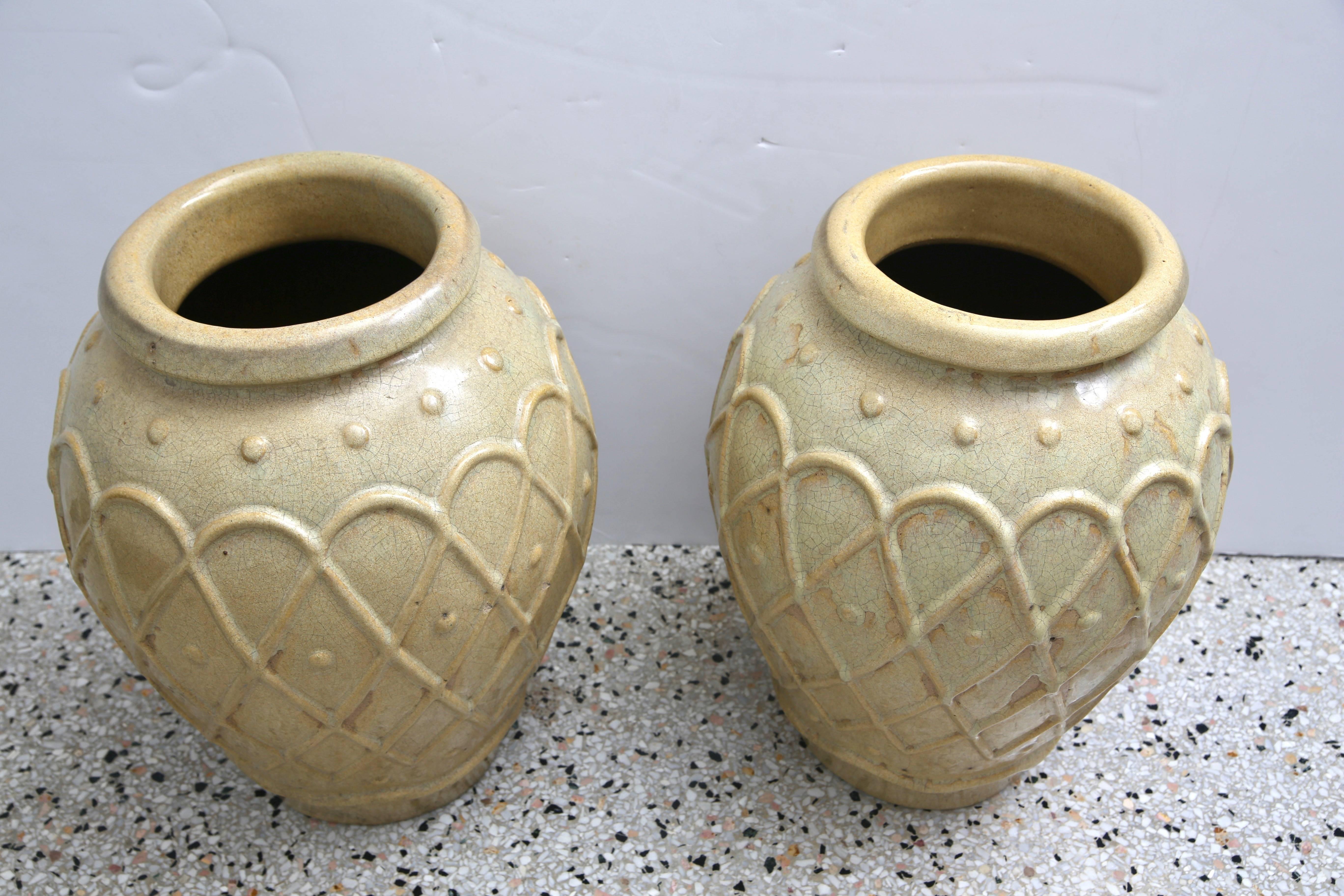 This stylish pair of American Art Deco era glazed pottery urn were created by the Galloway Pottery workroom based in Philadelphia, Pennsylvania. They were recently acquired from a Palm Beach estate. 

Note: Image #3 has the incised Galloway mark.