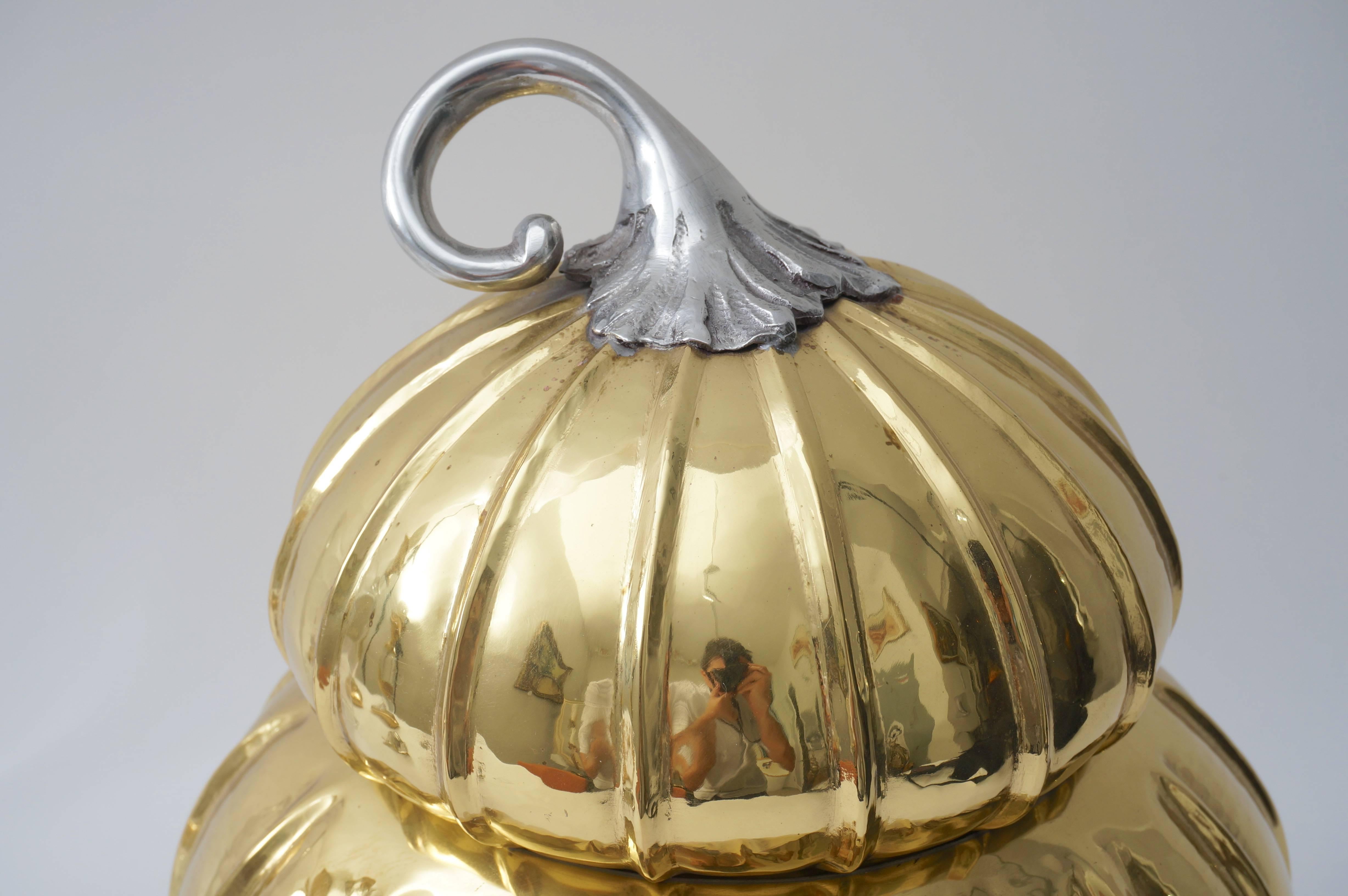 This stylish handcrafted, melon-form ice bucket in brass and silver plate was fabricated in Italy and dates to the 1970s-1980s.