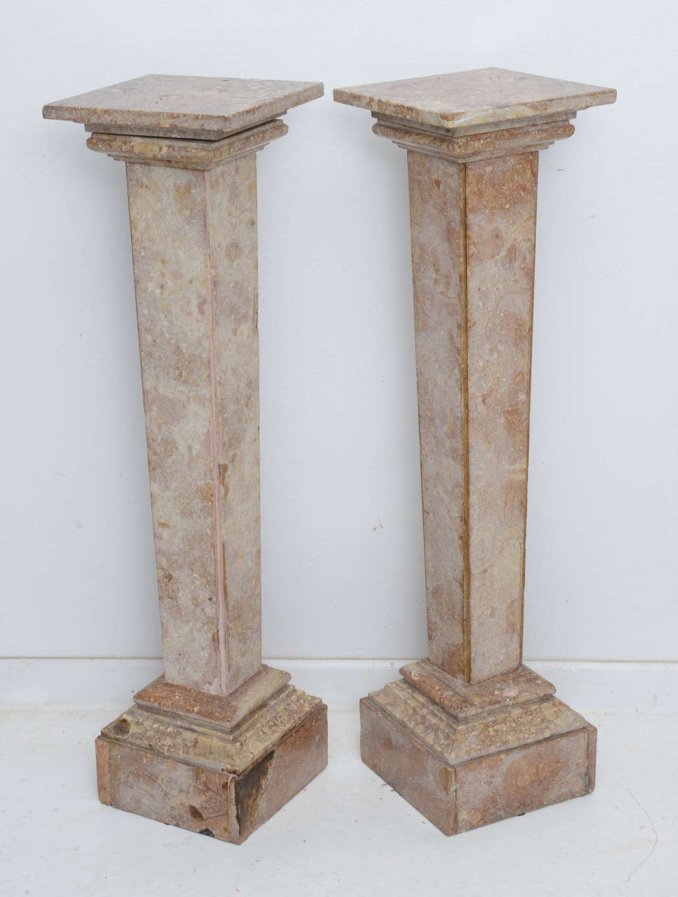 This stylish pair of pedestals are in the clean line of the Louis XVI period and the fossilized marble is subtle in in color and patterns. 

