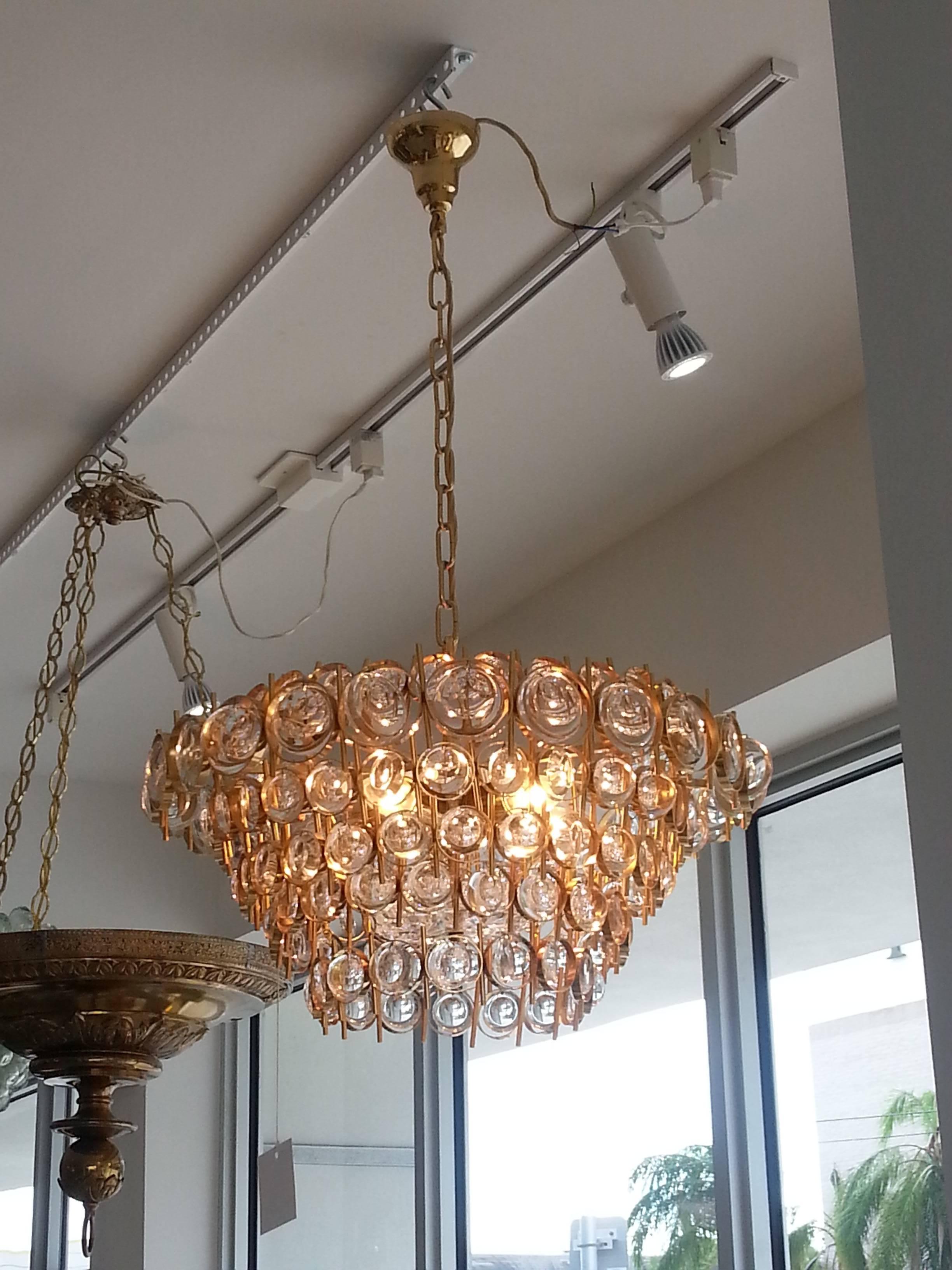 This beautiful chandelier was produced in the 1970s by Palwa of Germany, a firm known for its "Jewel Crystals".

The piece epitomizes modern glamour with its 24-karat gold-plated finish and its 140 optic- discs that sparkle and glisten