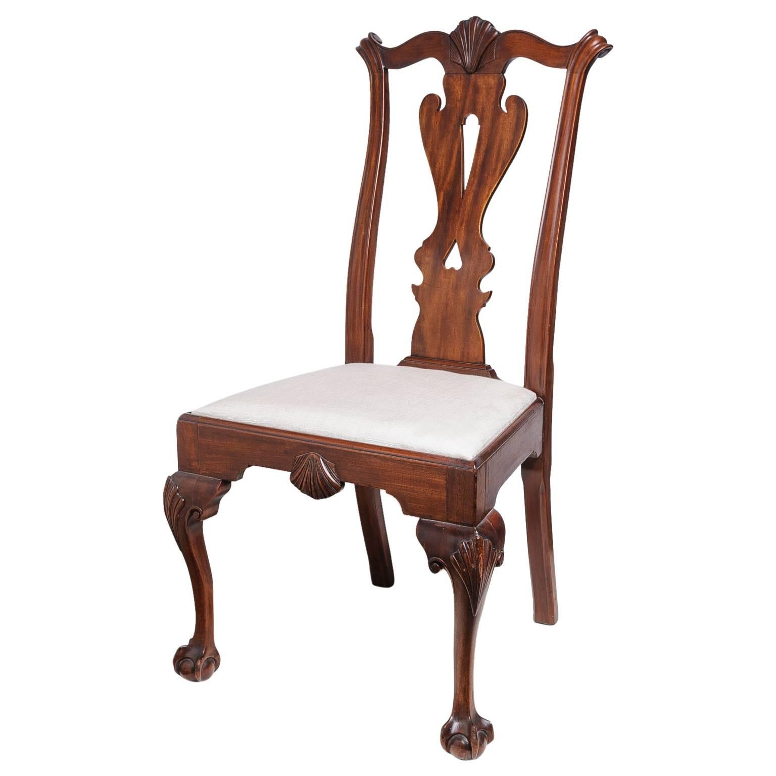 This set of six Thomas Chippendale style dining room chairs are mid-late 19th century copies of an 18th century chair. The wood is mahogany and is hand-carved and joined with details such as the ball and claw foot, cabriolet leg, serpentine crest,