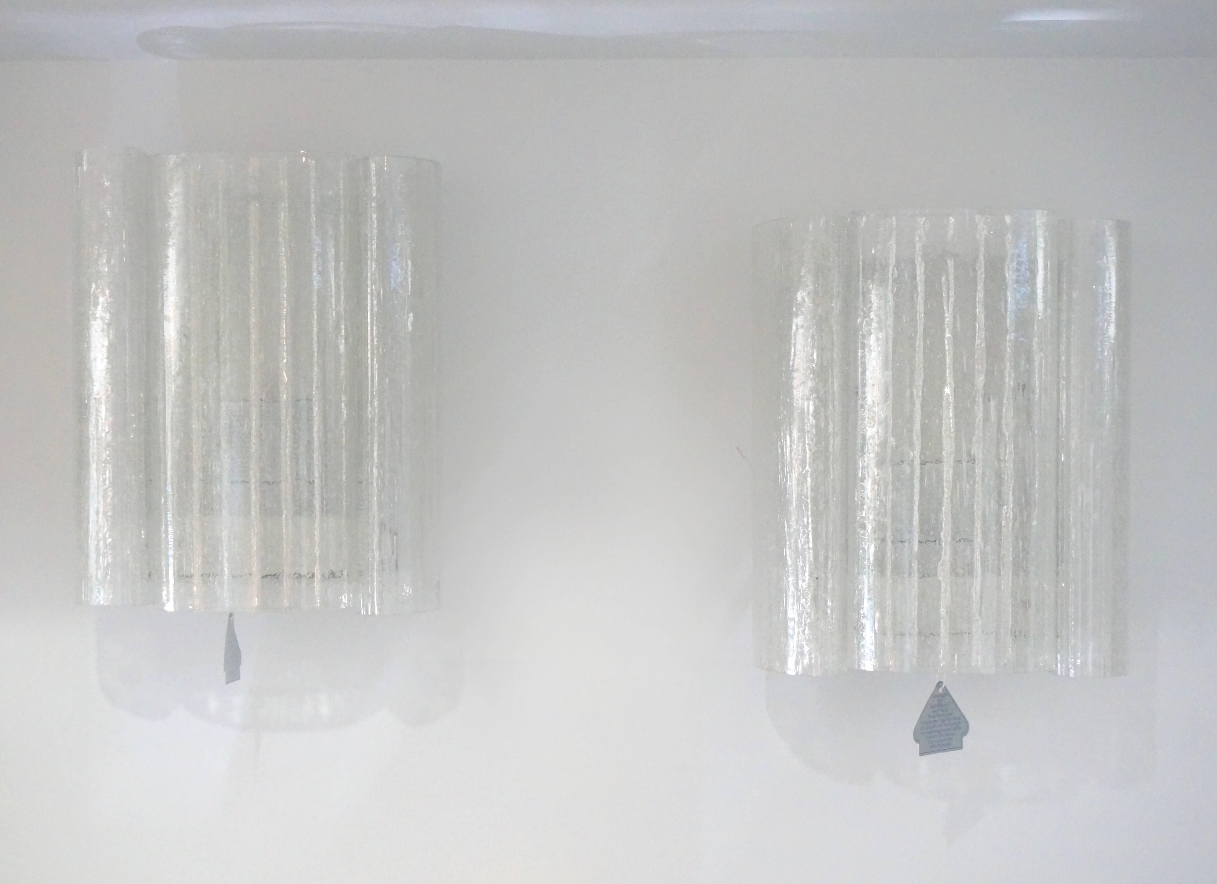This pair of wall sconces date from the 1960s and were manufactured by the iconic firm of Doria Leuchten. Each sconce has three molded-glass sections with an eisglas texture to them. The glass sections are flat on the exterior and the interior has a
