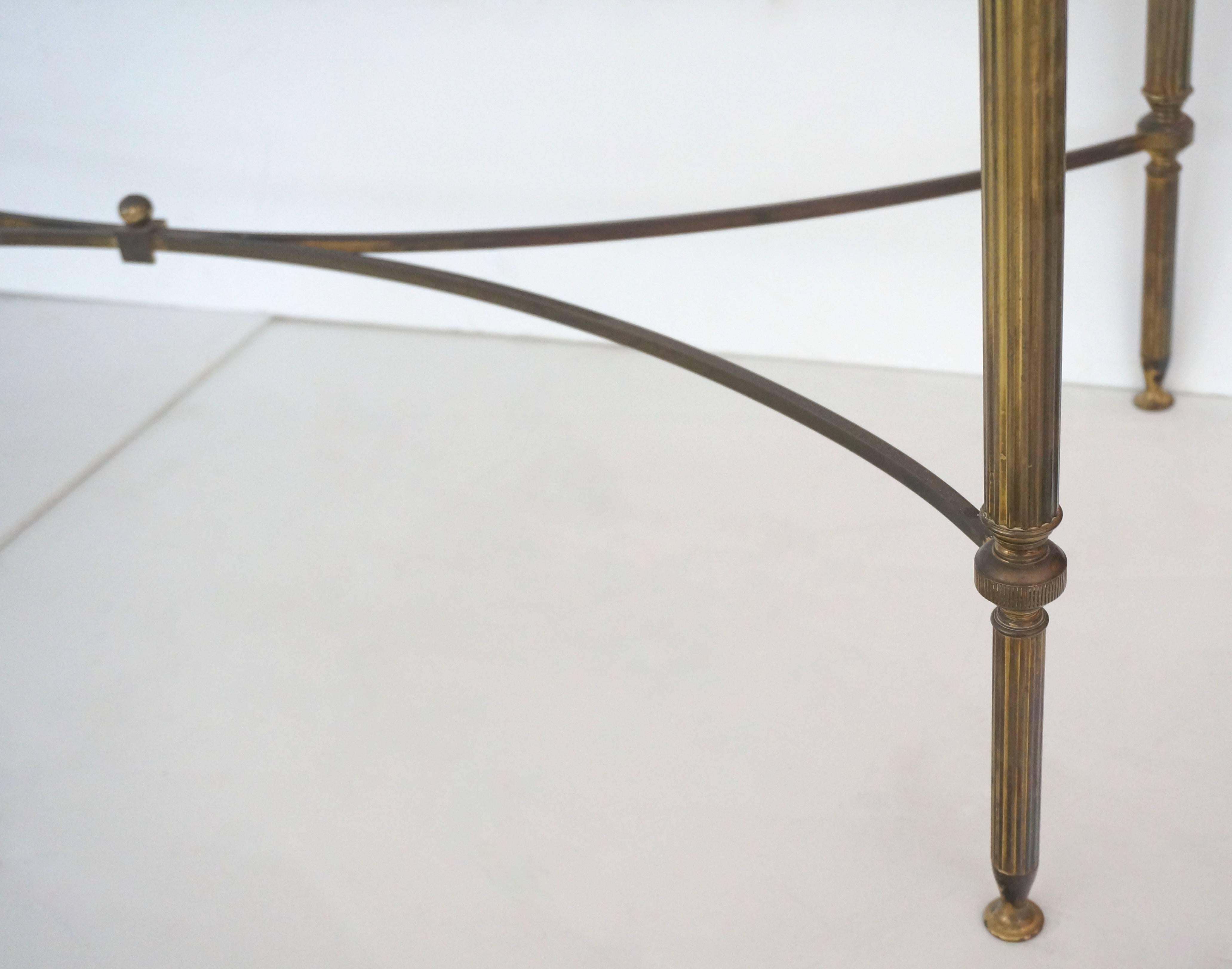 This rectangular cocktail table was purchased in London and is very much in the style of pieces created by Maison Jansen in the 1950s. The brass has mellowed to and antique finish and the glass has just been replaced.

For best net trade price or