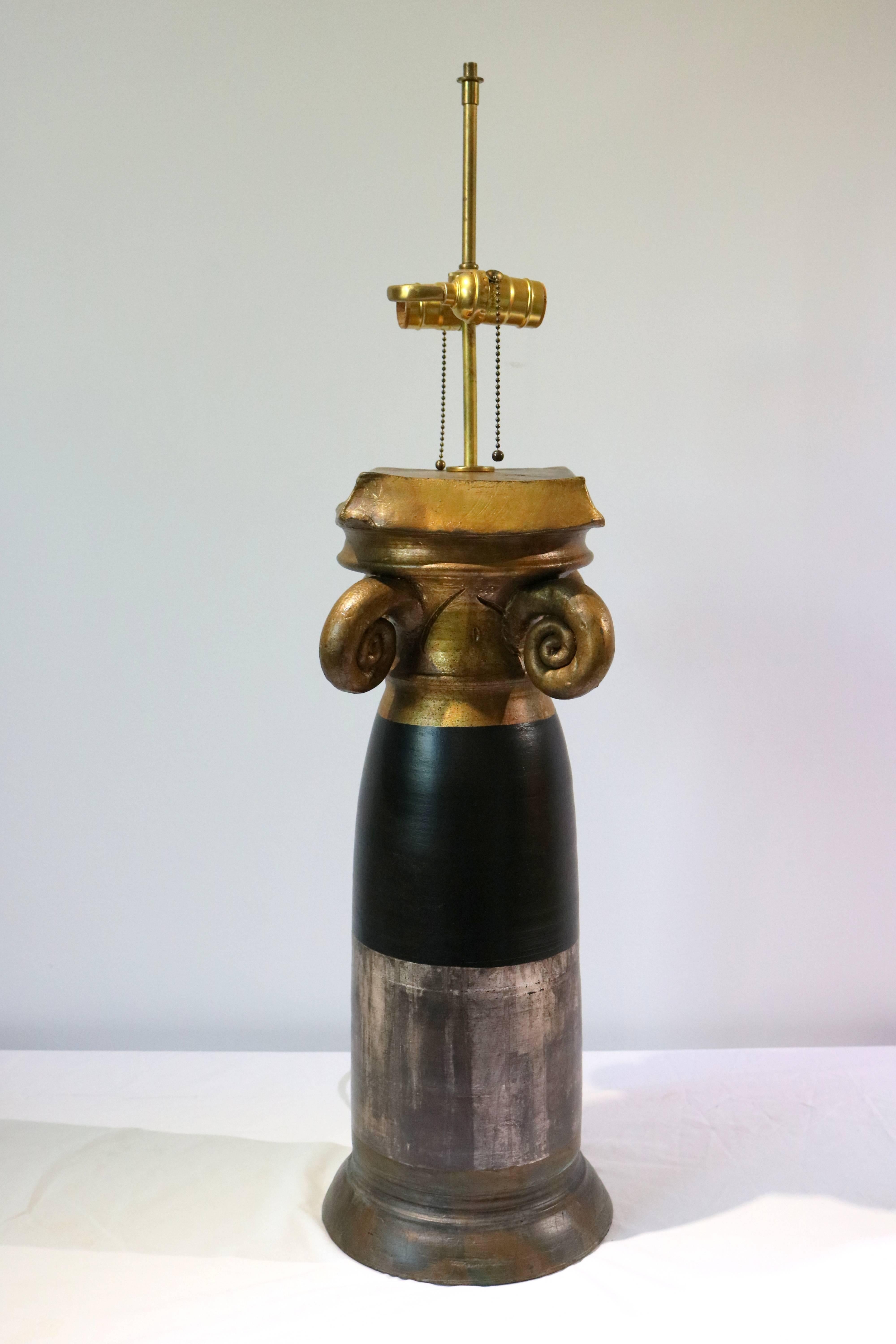 This stylish table lamp is by the American designer/artist Burts Cason and dates from the 1980s. The form is cast plaster which has been hand-finished in silver, black and gold and is signed by the designer/artist.

Note: Shade dimensions are