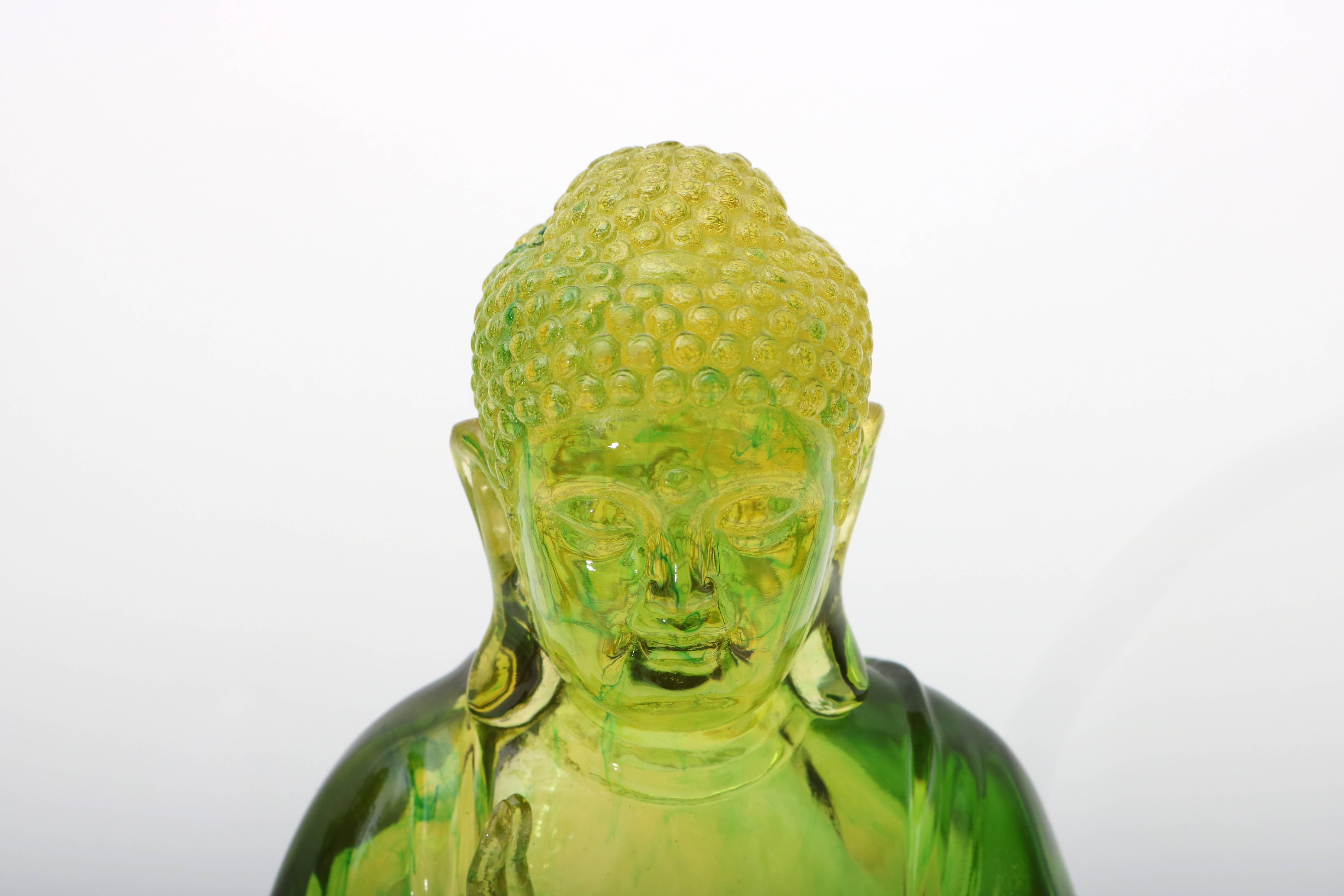 This vintage Buddha sculpture takes on the appearance of jadeite crystal as the light catches the folds in his garments. The base is a black laminate which gives the piece a great presence.

For best net trade price or additional questions