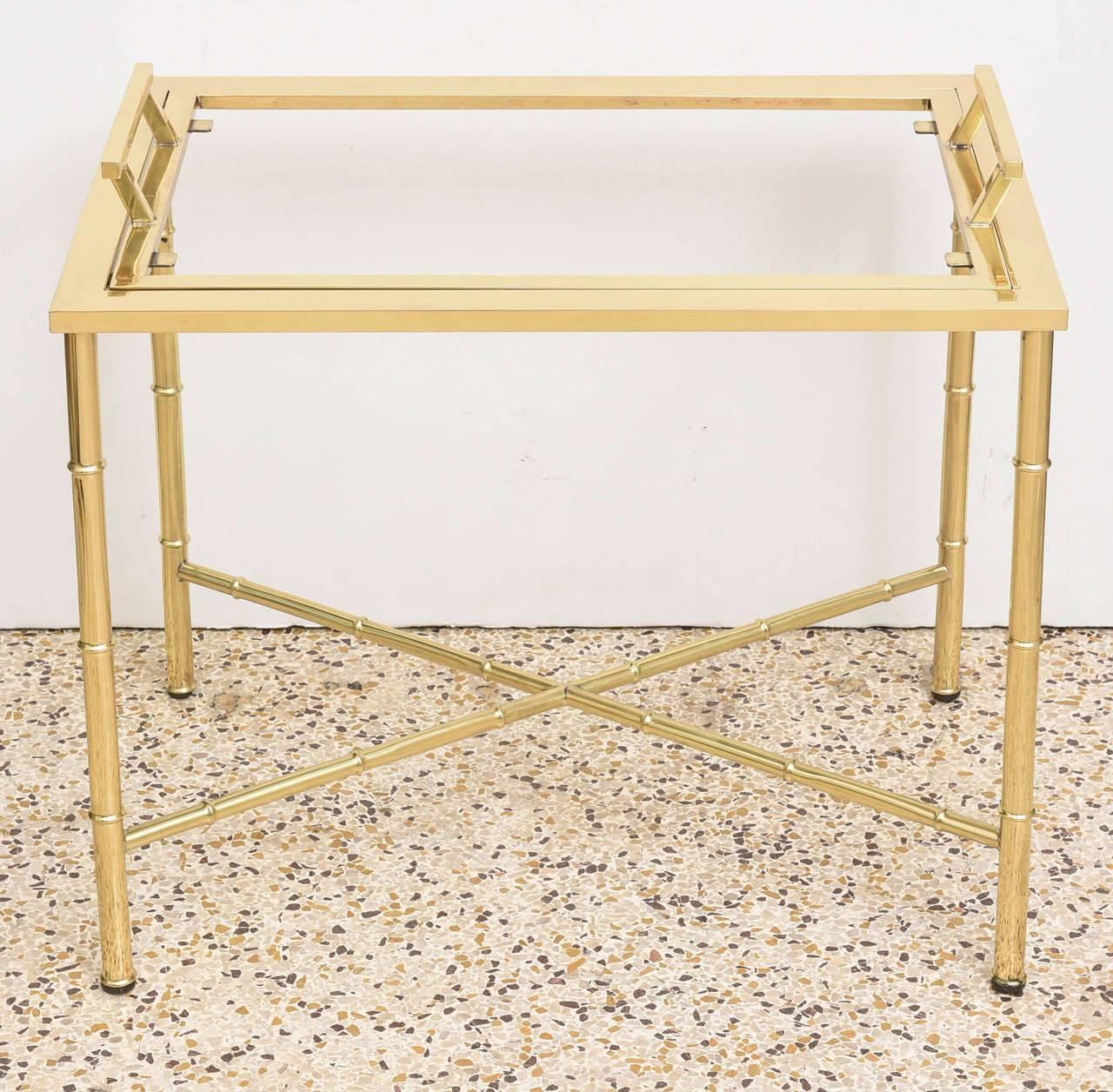 This stylish polished brass faux bamboo and glass cocktail table dates to the 1960s-1970s and was created by Mastercraft. The piece has been professionally polished and clear coated. 

For best net trade price or additional questions regarding