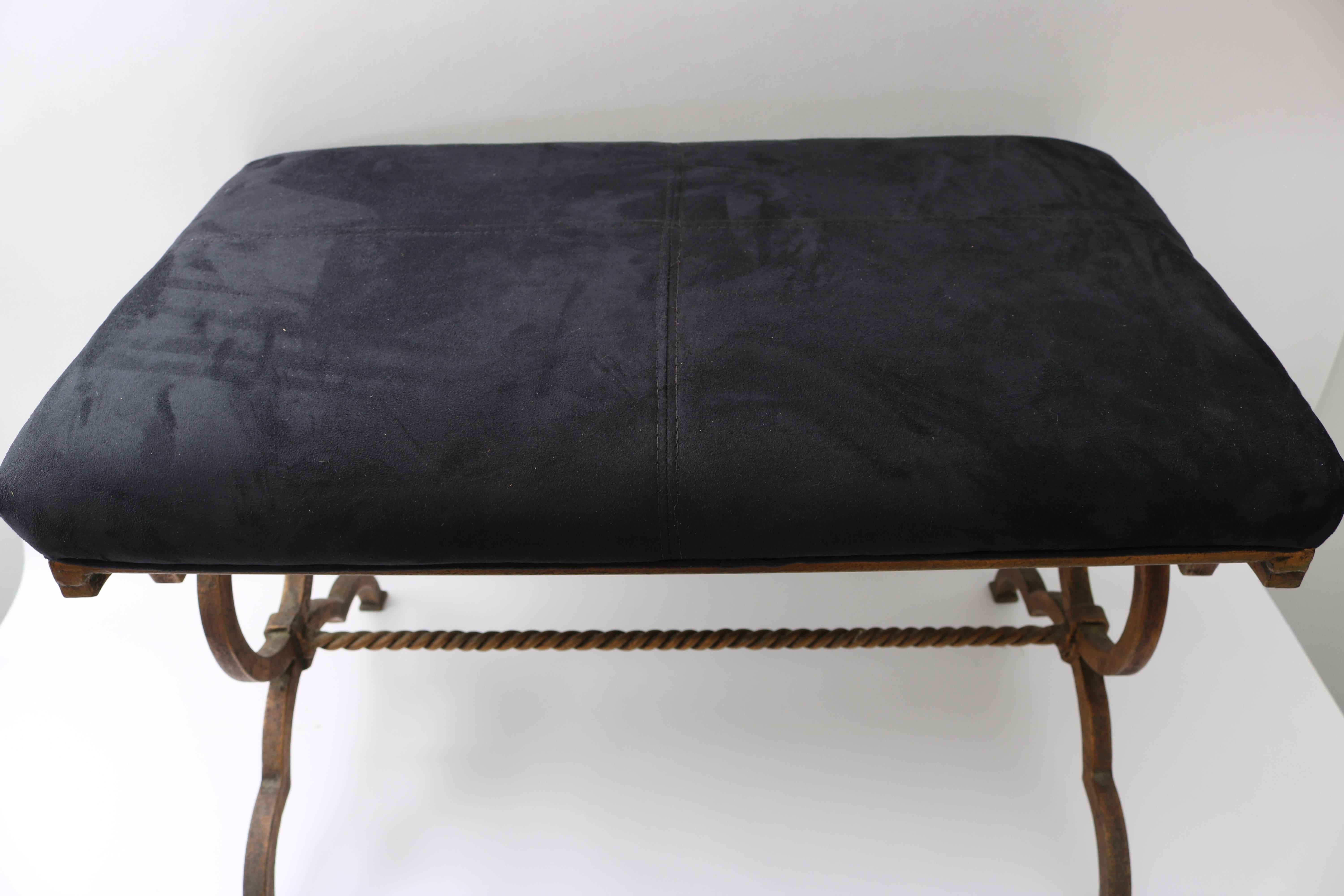This stylish Gilbert Poillerat gilt bronze bench was recently purchased from a Palm Beach estate and will make the perfect piece for your entry hall, vestibule or perhaps dressing table. The black suede contrast handsomely with the gilt