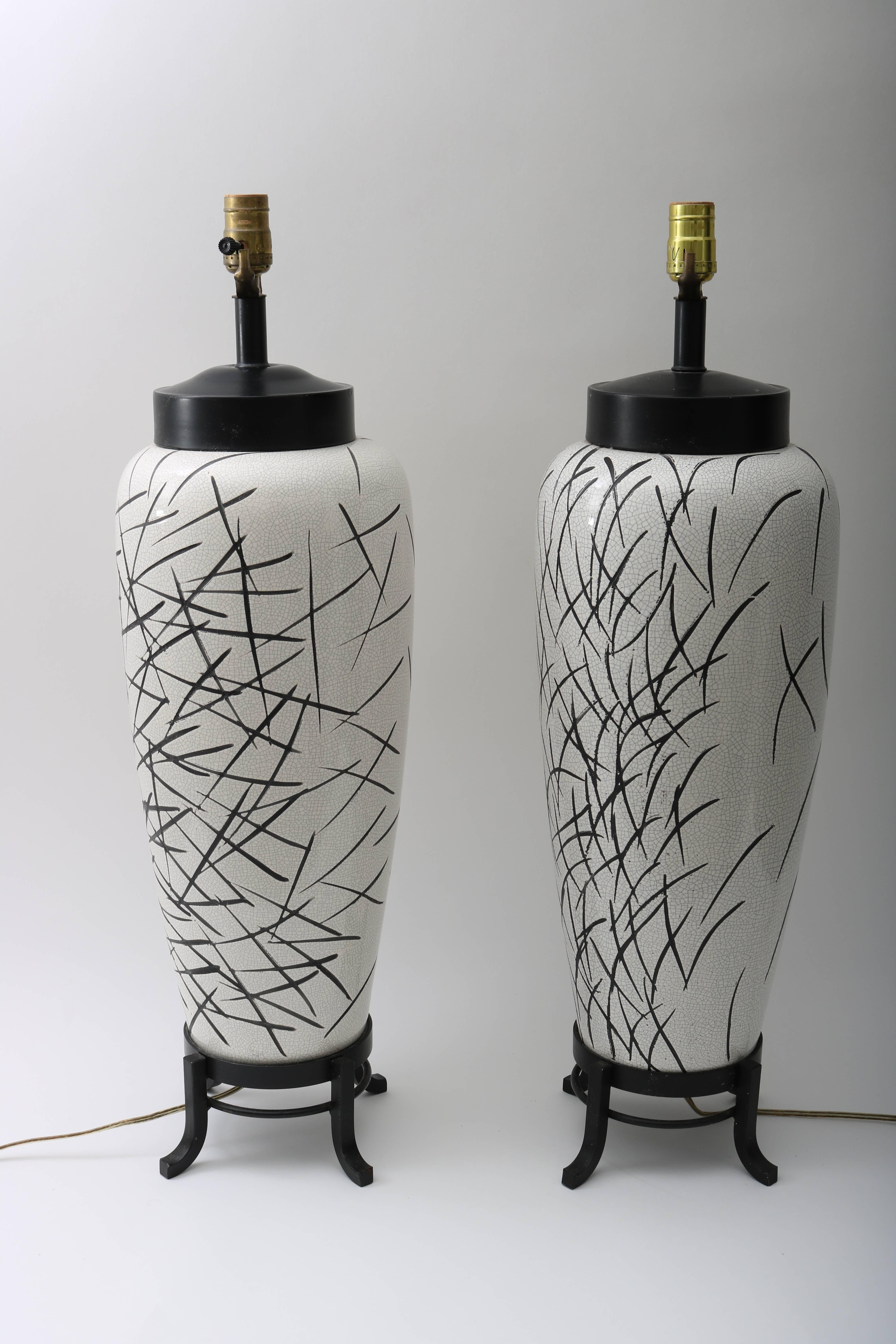 This stylish pair of table lamps date from the 1980s and are fabricated in glazed ceramic with a modern graphic detail of stroke marks. The pieces are not detailed identically yes have a great balance as a pair.

      