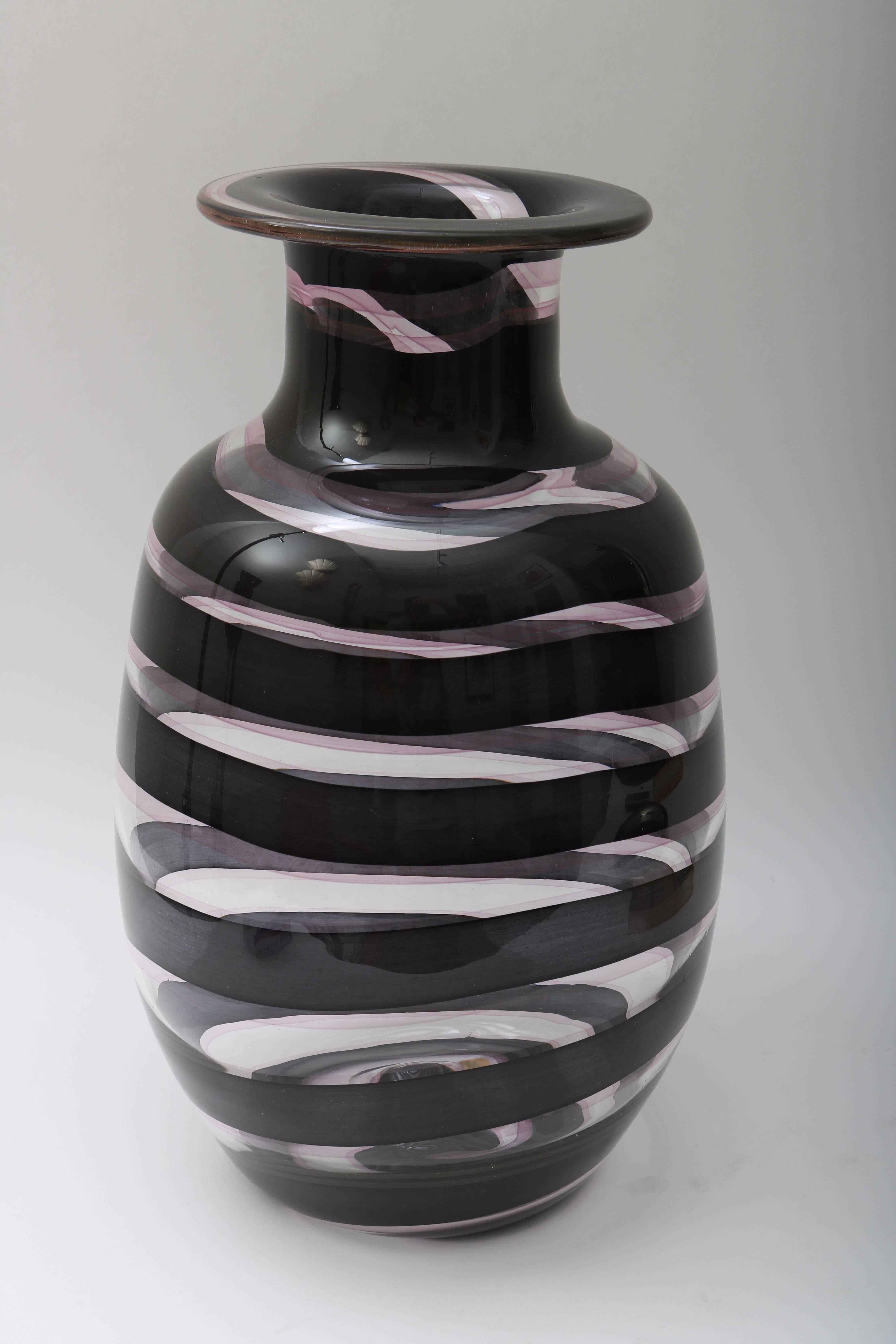 This large-scale Murano glass vase was recently acquired from a Palm Beach estate and dates to the 1980s. The dark aubergine swirl pattern works beautifully with the clear and translucent colors.

For best net trade price or additional questions