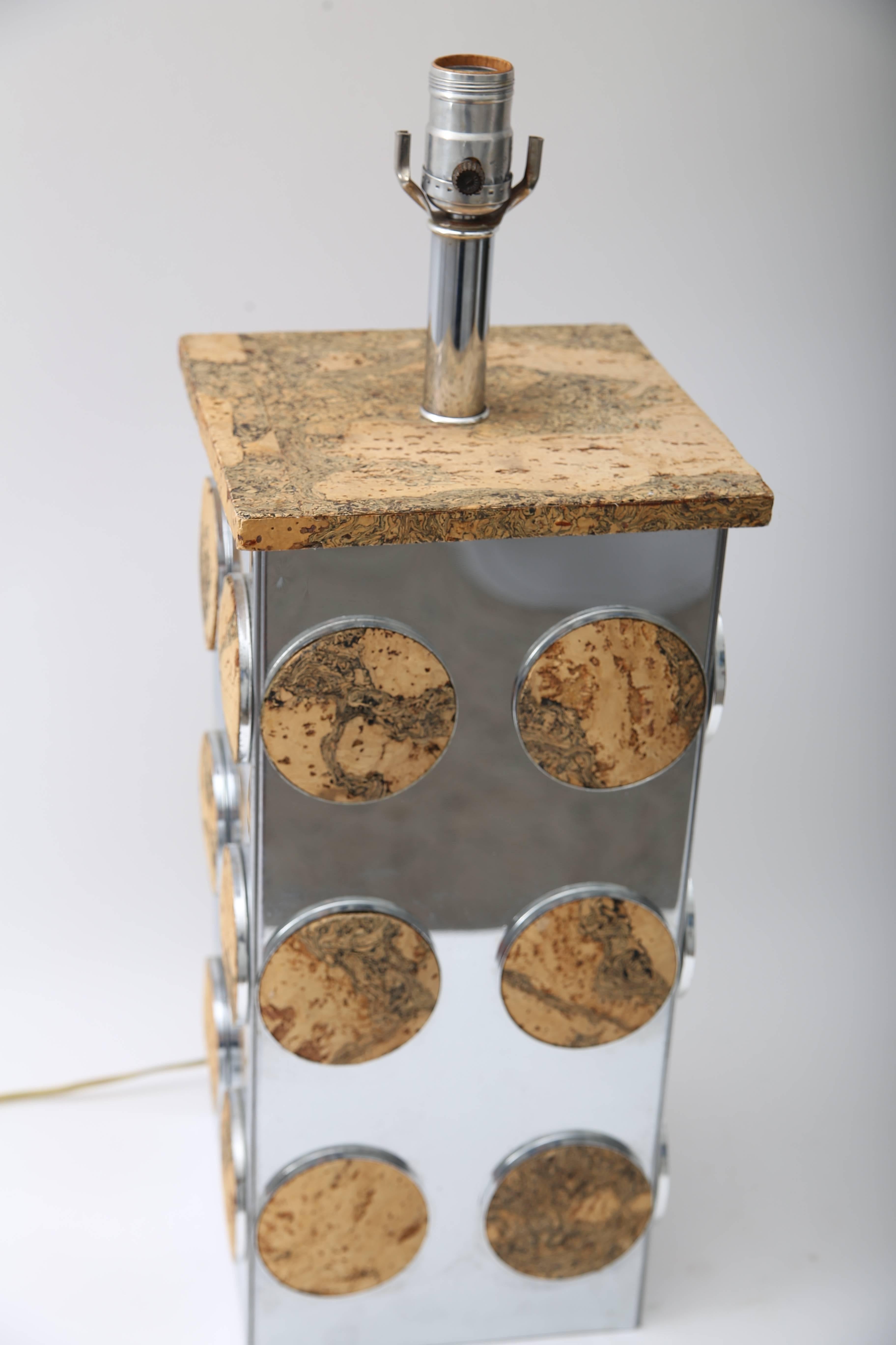This stylish table lamp dates to the 1970s and is fabricated in cork and polished chrome in a 