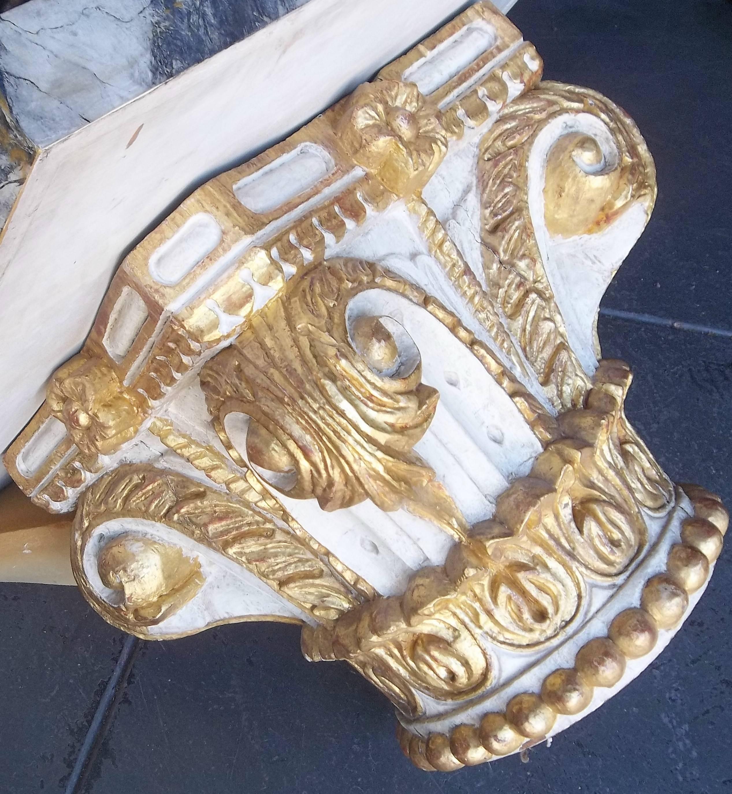 With a later imitation marble top. The architectural capital of carved wood, probably early 19th century with later gilt or refreshed decoration. Showing usual signs of time, wear and use. As being solid wood (heavy) this will not go UPS and will be