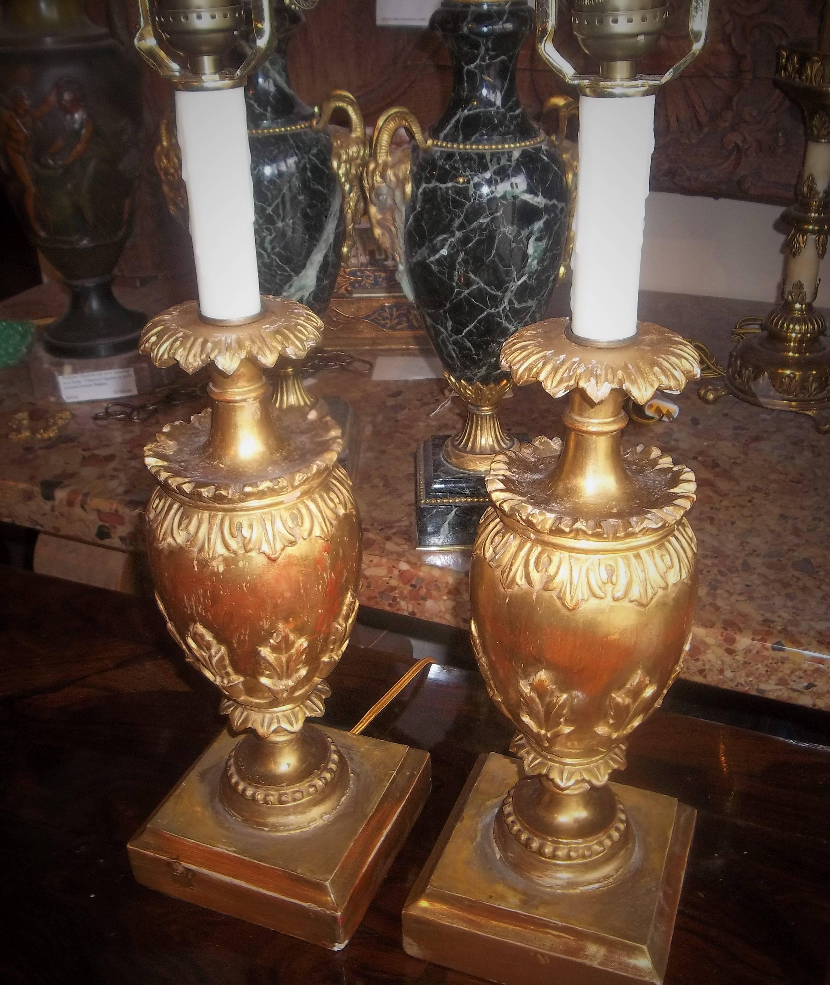 Probably early 20th century and originally as garniture vases. Pretty water gilding with red bole bleeding and chipping throughout. Probably older touch ups.
Lamp wiring can be undone to return as garnitures. 

Measure: Overall lamp height 19.5