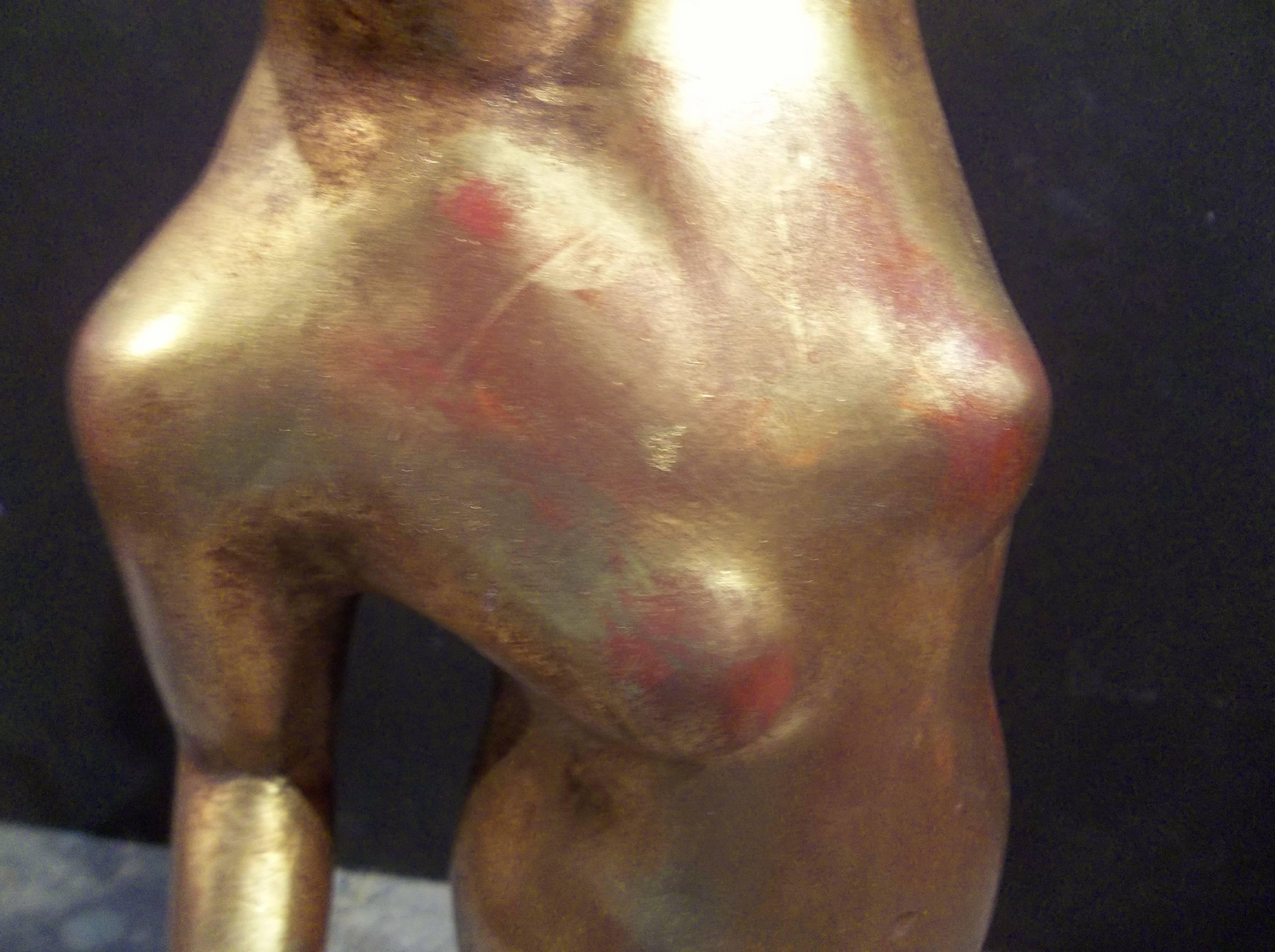 Probably French or Italian on marble base. Very stylized features suggestive of post World War II. 

Water gilt with red bole bleeding throughout. Minor wear, chipping, repair to appendix/abdomen area (more apparent in last photo). 

Sculpture