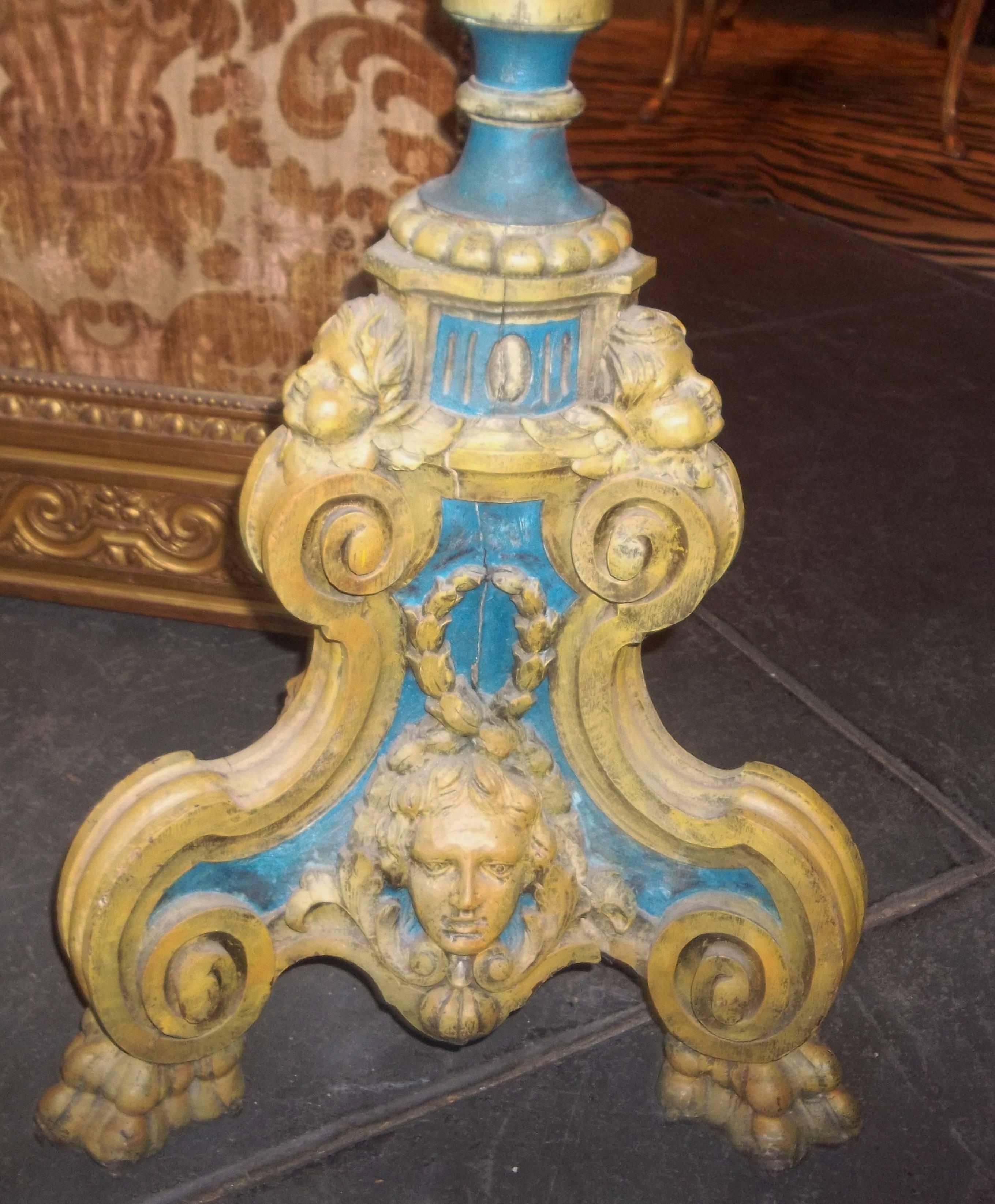 Putti (or cherubs,) floral garlands and fluted shafts. Each five lights. The bottom bases hand chiseled single chunks of wood. 

Blue and yellow paint.

Possibly French . Baroque to Rococo transitional style.

With usual wear, dents, dings, nicks