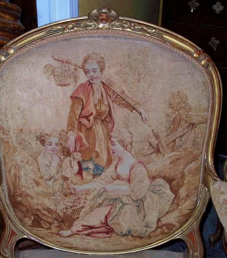 Well carved and sturdy gilded frames with red bole bleeding throughout . The tapestry backs in good antique condition . The seats less so with separations, and repair / touchups ( some re -weaves and stitching at seat edge )   The arms in antique