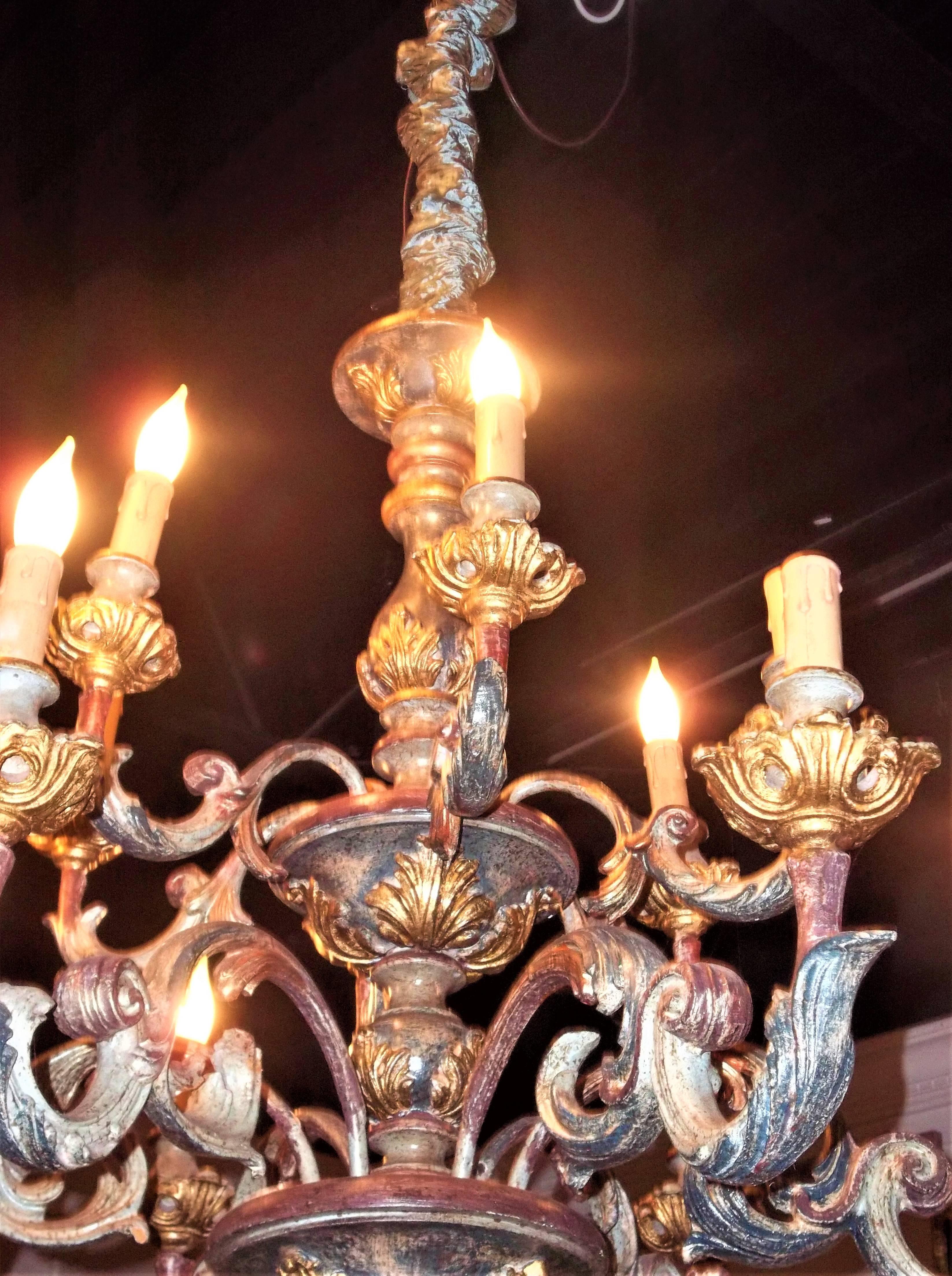 20th century. In Italian Rococo or Louis XV taste, rewired to USA specs. Unmarked or labeled as to origin so just a best guess Italy. Two tiers of six lights each. Measures: 32 tall (excluding chain) 31 wide.