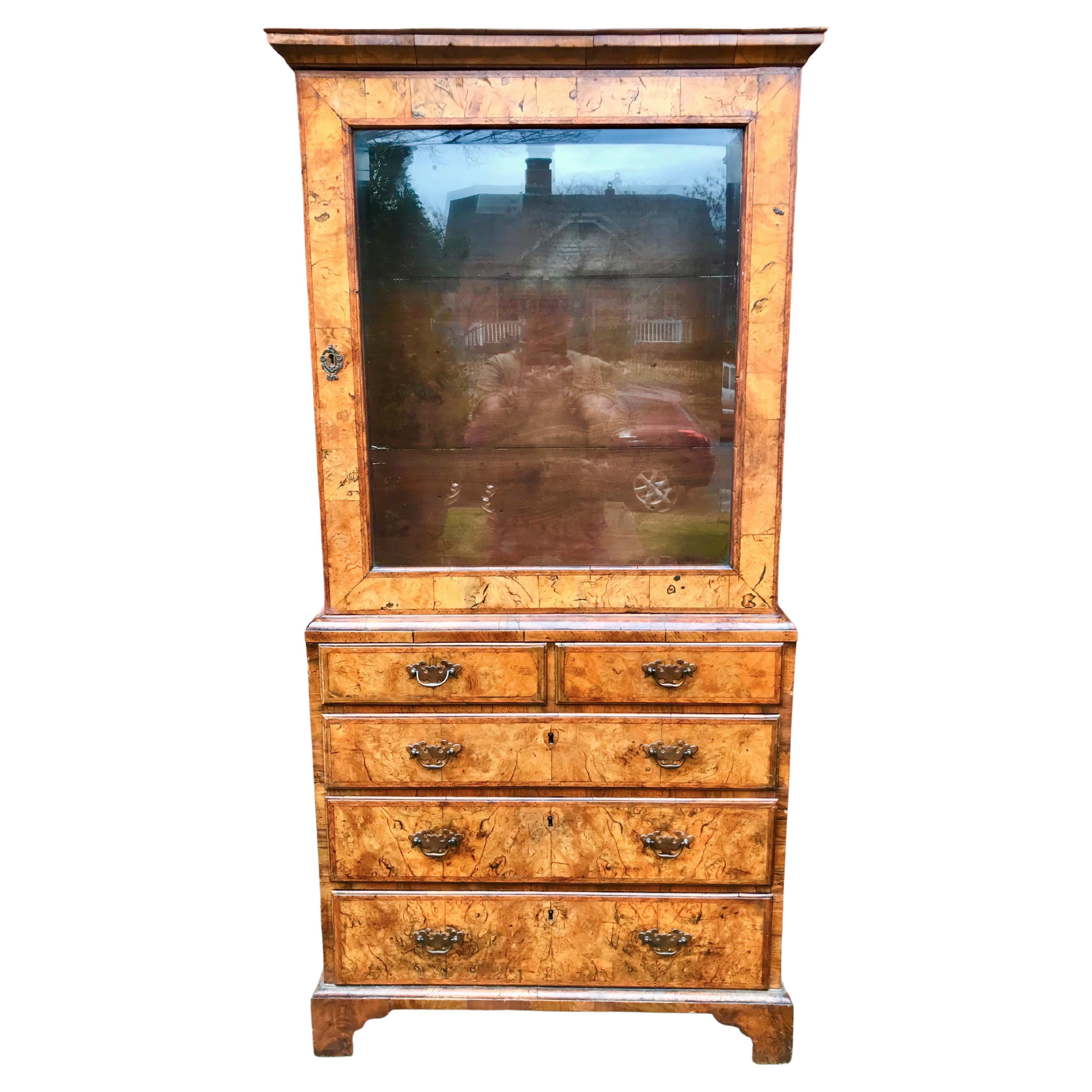 A diminutive bureau bookcase cabinet with stunning veneers /solid walnut boards. Truly pretty faded colors and patina, Mottled fading throughout. Mellow, warm ,faded appeal. Beveled glass door. Rare small size, basically a book cabinet on a walnut