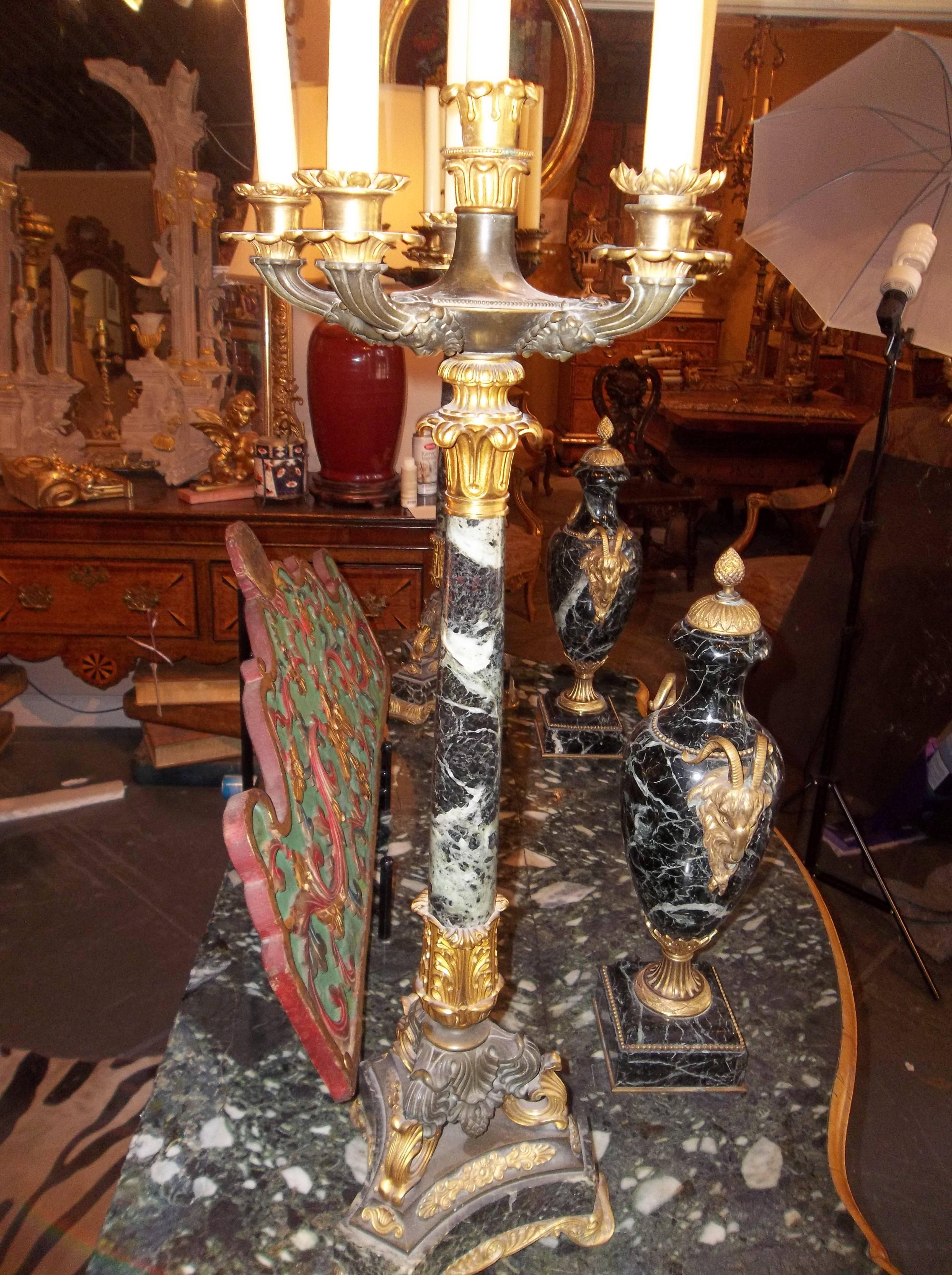 Late Empire or Charles X marble, bronze and gilt bronze candelabra. Impressive size and weight (35 lbs); the bronze and ormolu finely cast and chased. The five arms attached with masks underneath. Some bobeches and candle drip cups have been