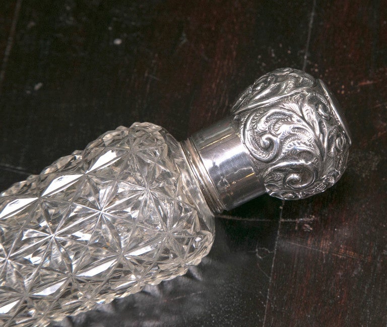 This is part of a private collection that we acquired. The collection consists of 350 pieces/period 18th & 19th century.
Antique American 1883 Sterling and Crystal Cylinder Perfume Bottle.
The cuts are very brillant and the characteristics are