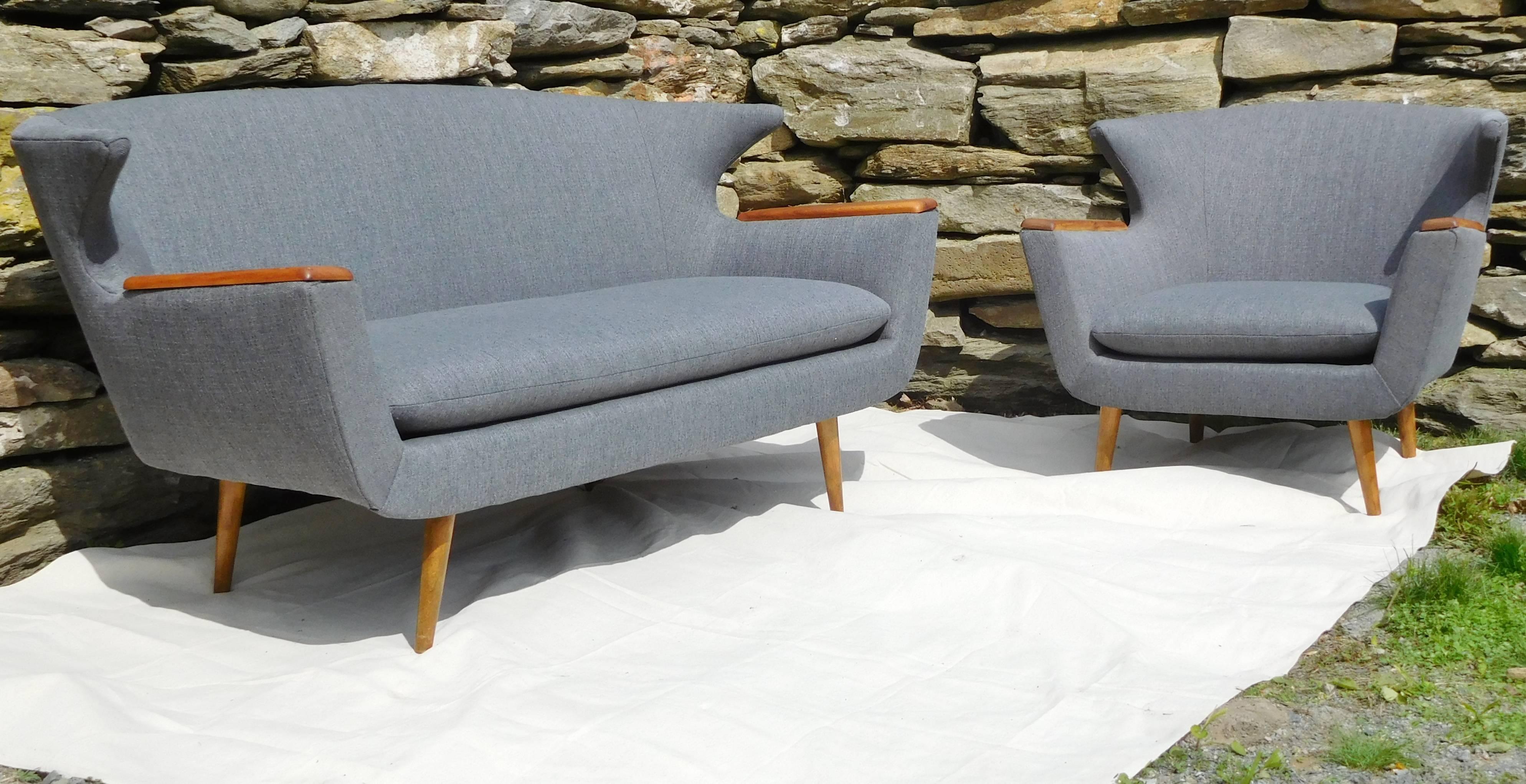 This two-piece set in sleek minimalist design has been reconditioned with new ash-grey fabric upholstery. The wing-backs and overall look are reminiscent of furniture by Hans-Erik Johansson, Kerstin Horlin-Holmquist, Hans Wegner, or Folke Jansson in