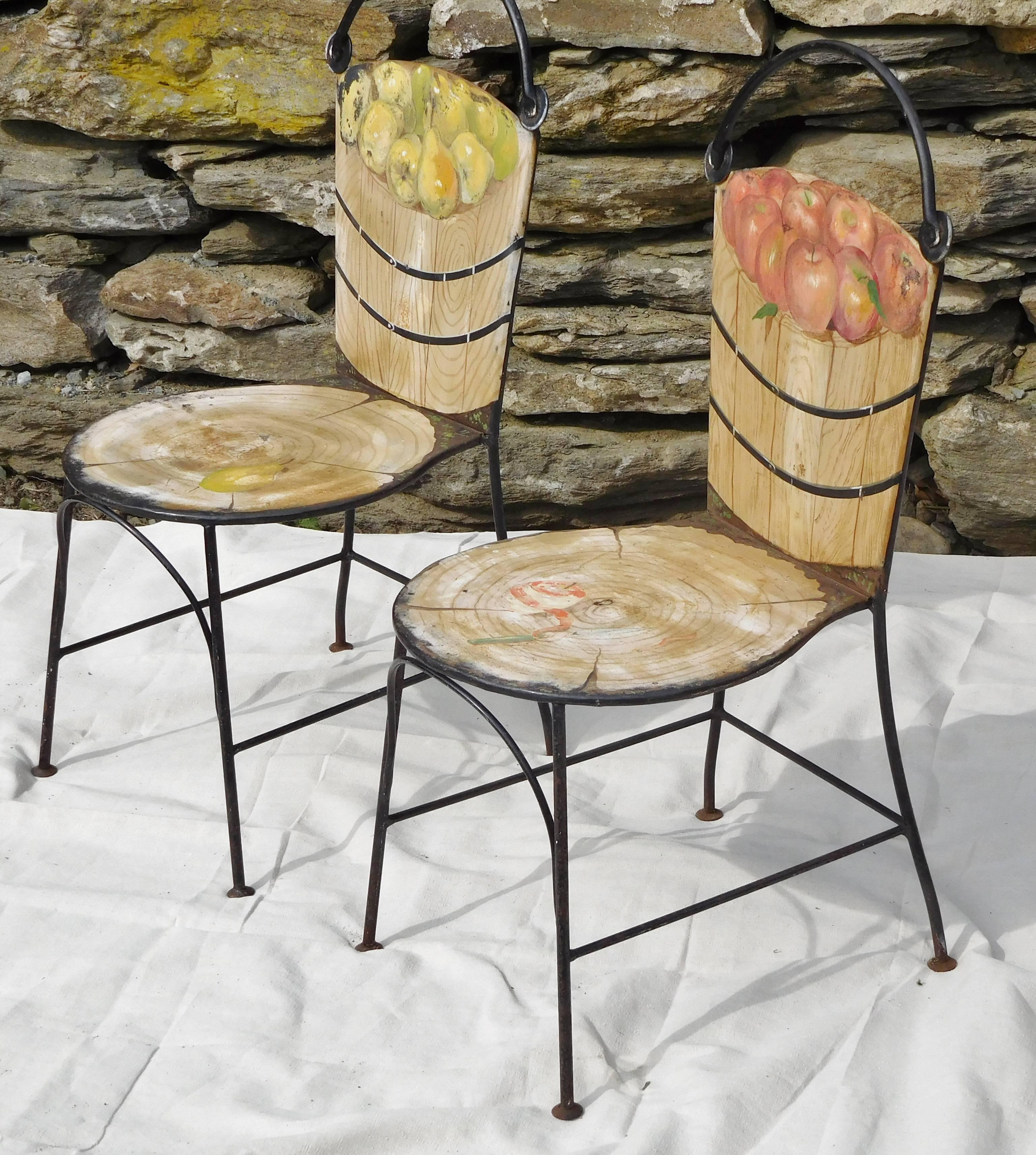 The famous basket chairs by antiques dealer and designer John Vesey (1924-1992) are shown here in a set of two, one depicting a wooden basket of pears and the other a wooden basket of apples. On the reverse side, the chair backs are painted as