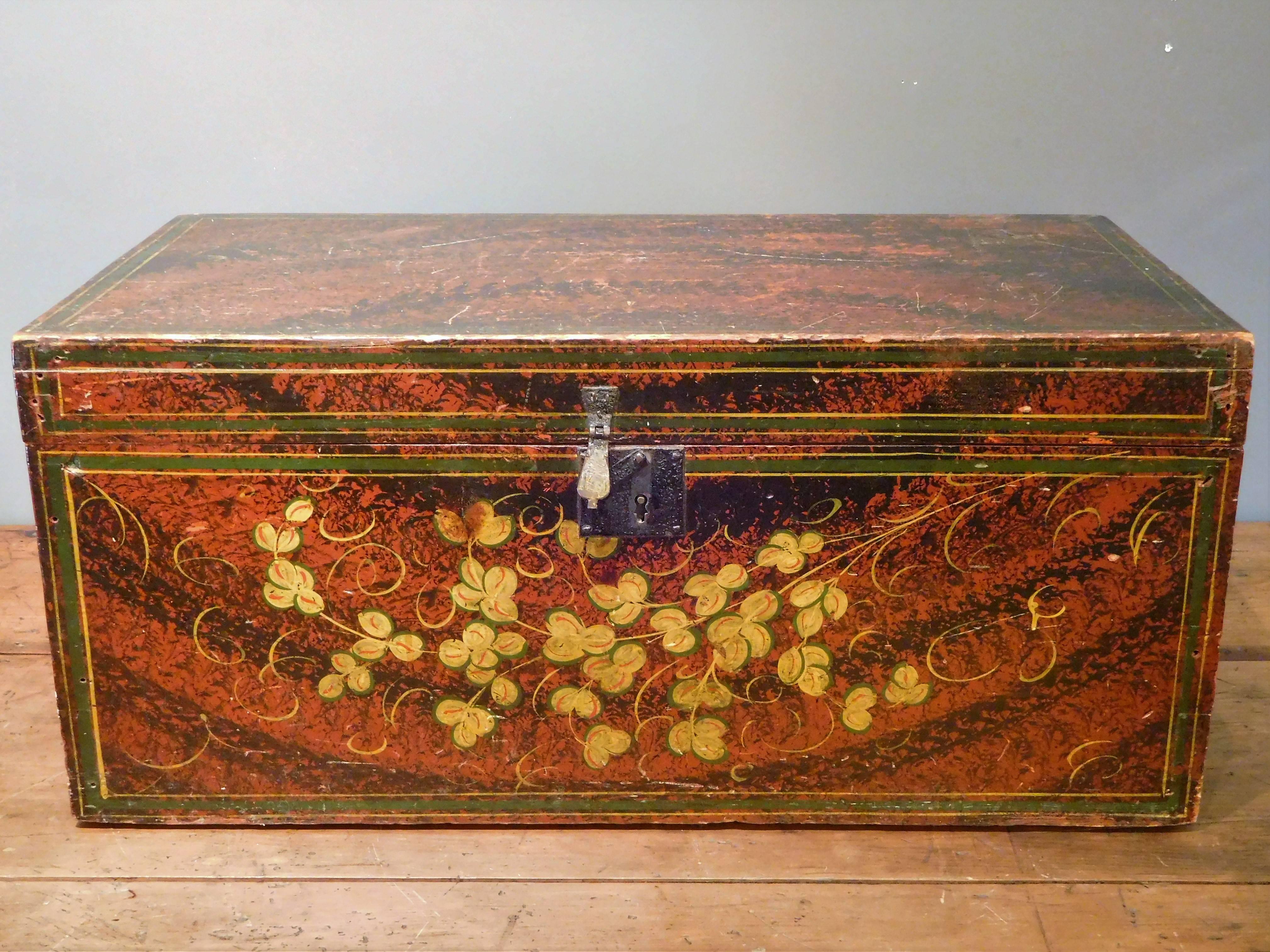 This handsome large document box is sponge-painted in black over red and has a spray of stenciled golden flowers along the front, with tendrils finished by hand. It is made of six pine boards with the lid attached by square iron hinges held in place