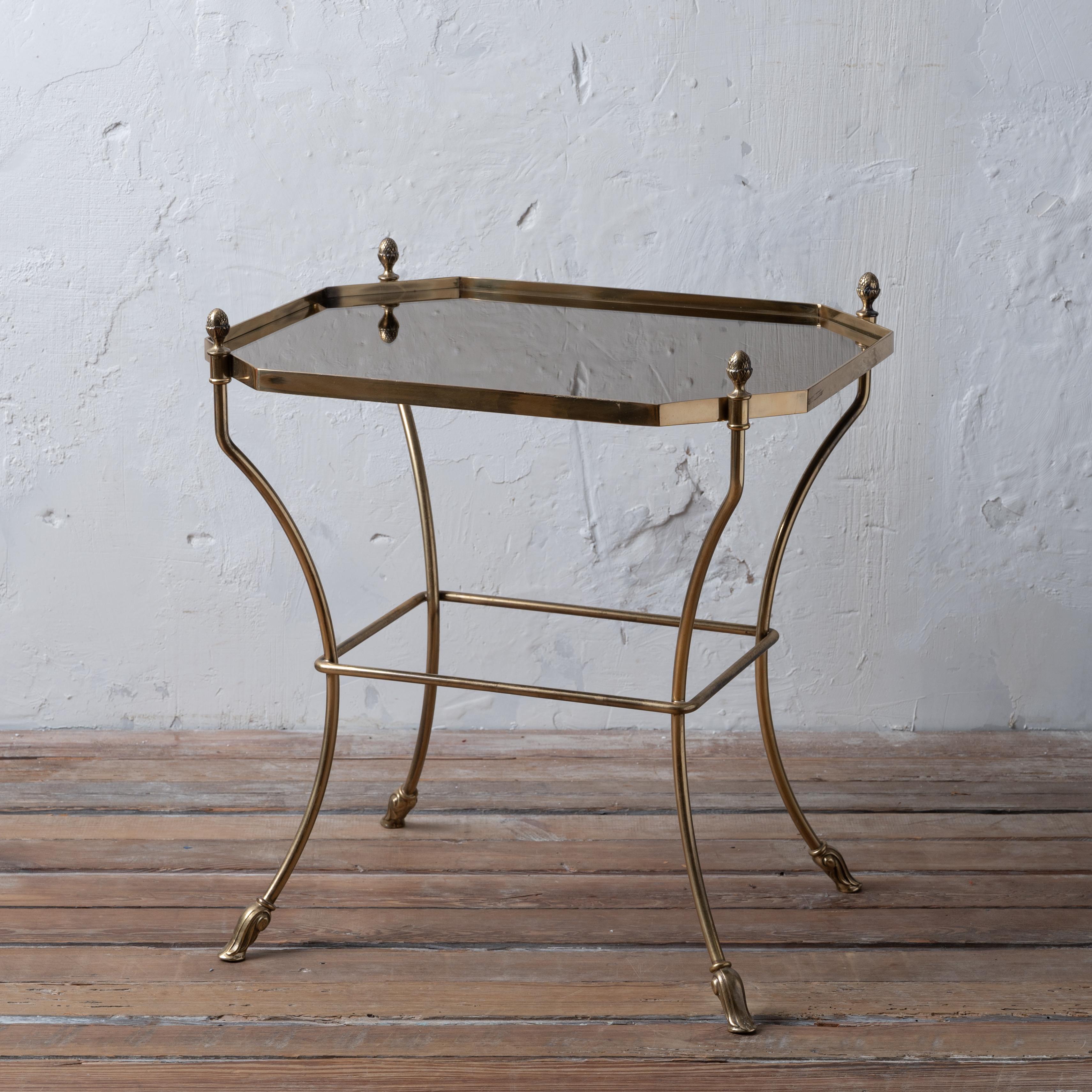 An Italian brass smoked mirror top cocktail table, circa 1970.



21 ¾ inches wide by 18 inches deep by 23 inches tall



