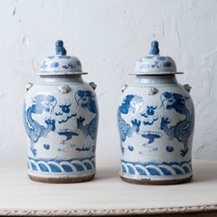 Pair of Chinese Blue and White Glazed Dragon Jars With Foo Dog Lid Finials