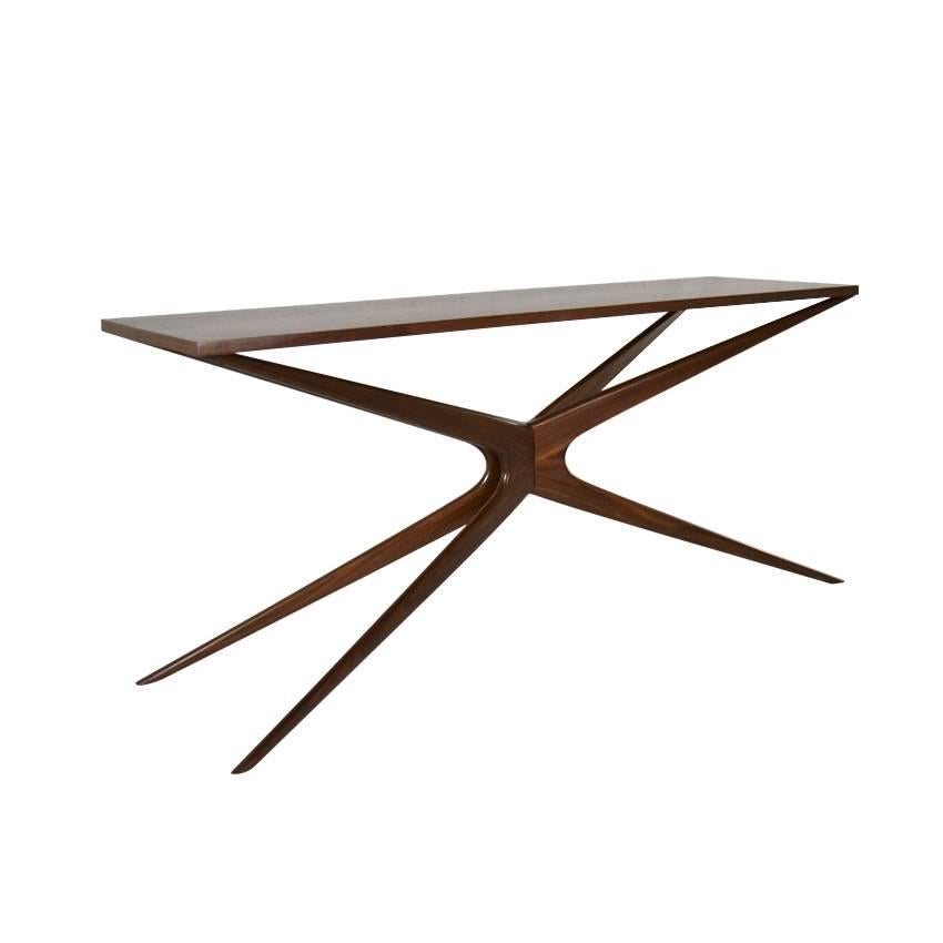 The Gazelle console table is a slender piece, with tapered legs and arms that converge in the center making an X-shaped base. The legs are handcrafted, and made of solid walnut. 

The design is largely inspired by iconic Italian furniture designer
