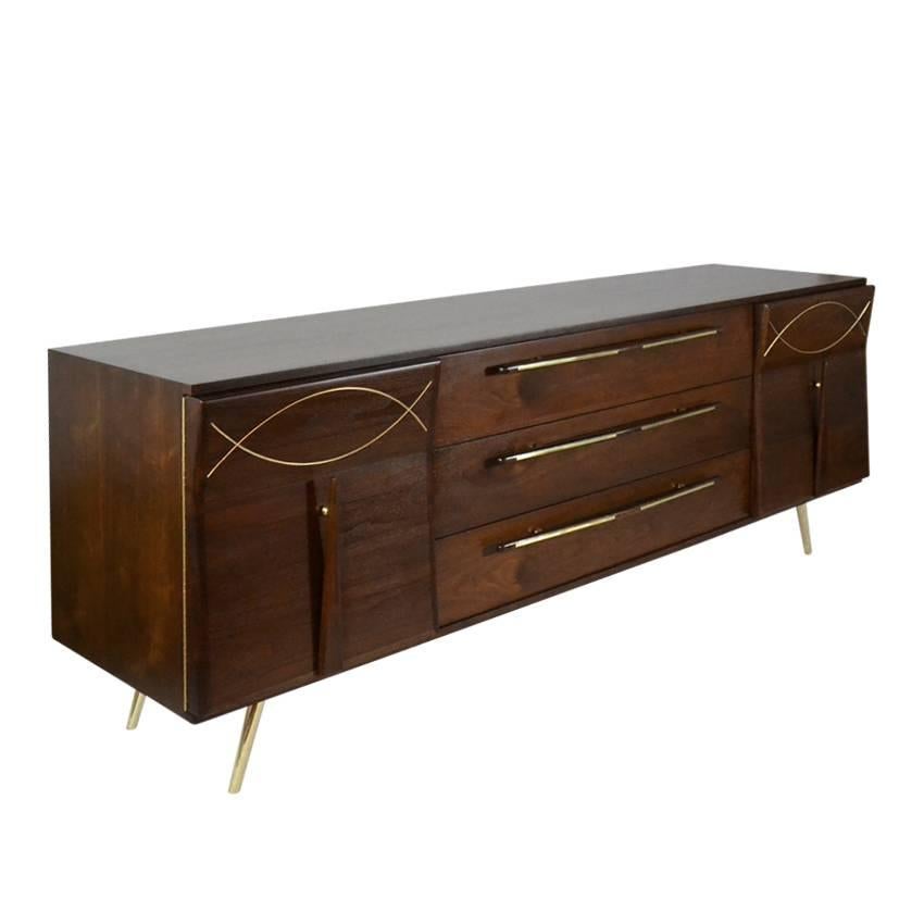 Sculptural design Mid-Century Modern walnut credenza or sideboard with inlaid brass detail and legs.

 