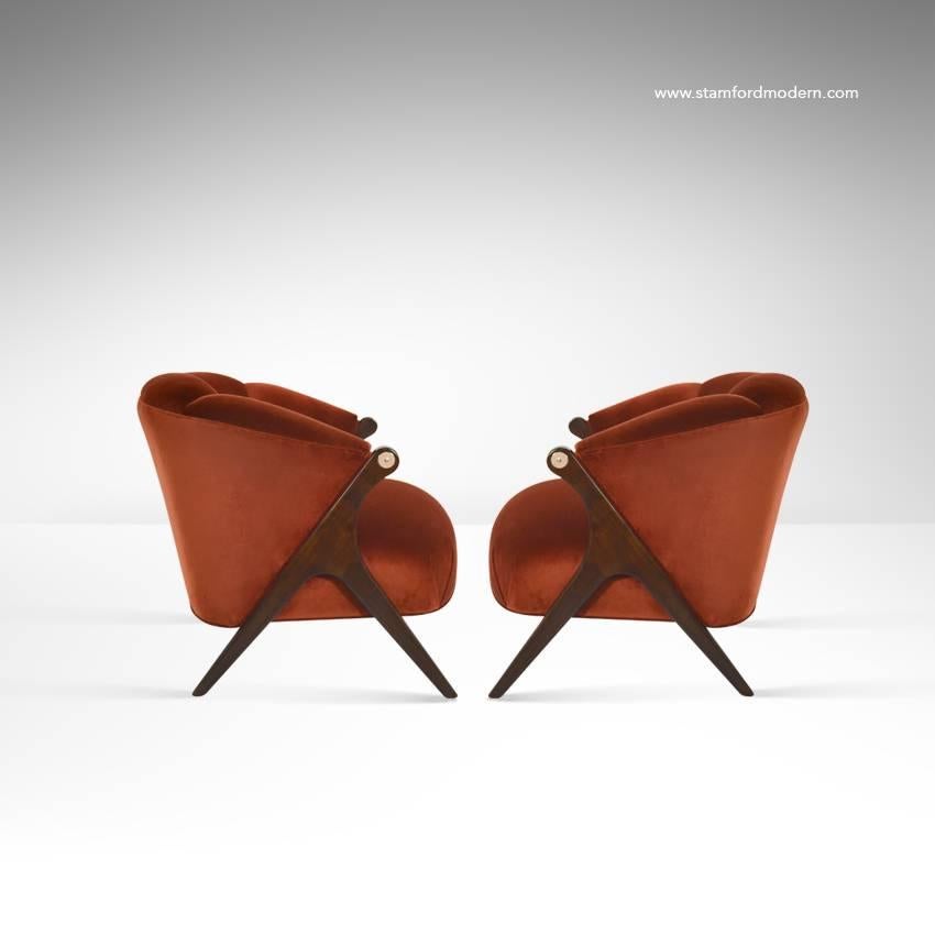 Handsome pair of lounge chairs by the Karpen Company of California, circa 1950s.

Newly upholstered in red velvet, sculptural walnut legs newly refinished. Nickel-plated details on arms.
  