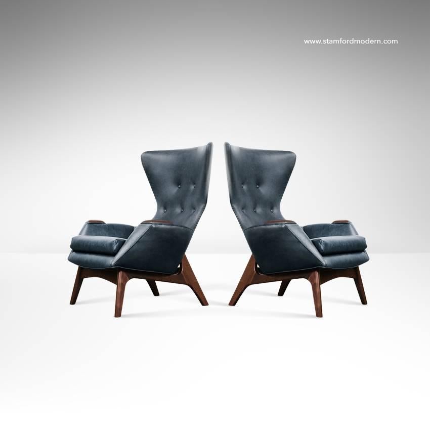 Stunning pair of high back, wing chairs designed by Adrian Pearsall for Craft Associates, circa 1950s. 

Sculptural walnut frames fully restored. Newly recovered in Echo Granite by Moore & Giles.