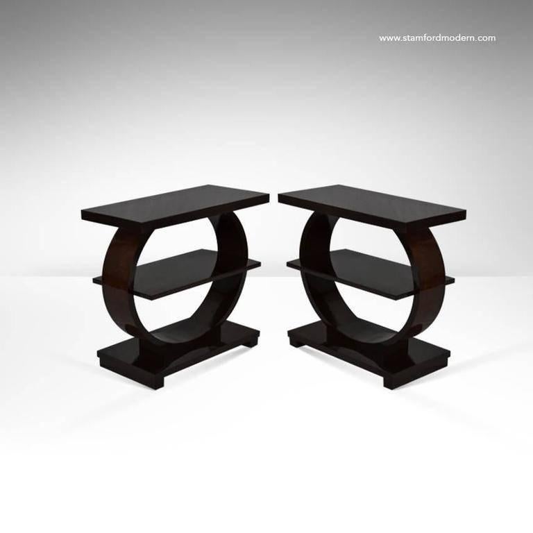 Handsome pair of Art Deco style side tables by Modernage. Fully restored to their original high gloss finish.