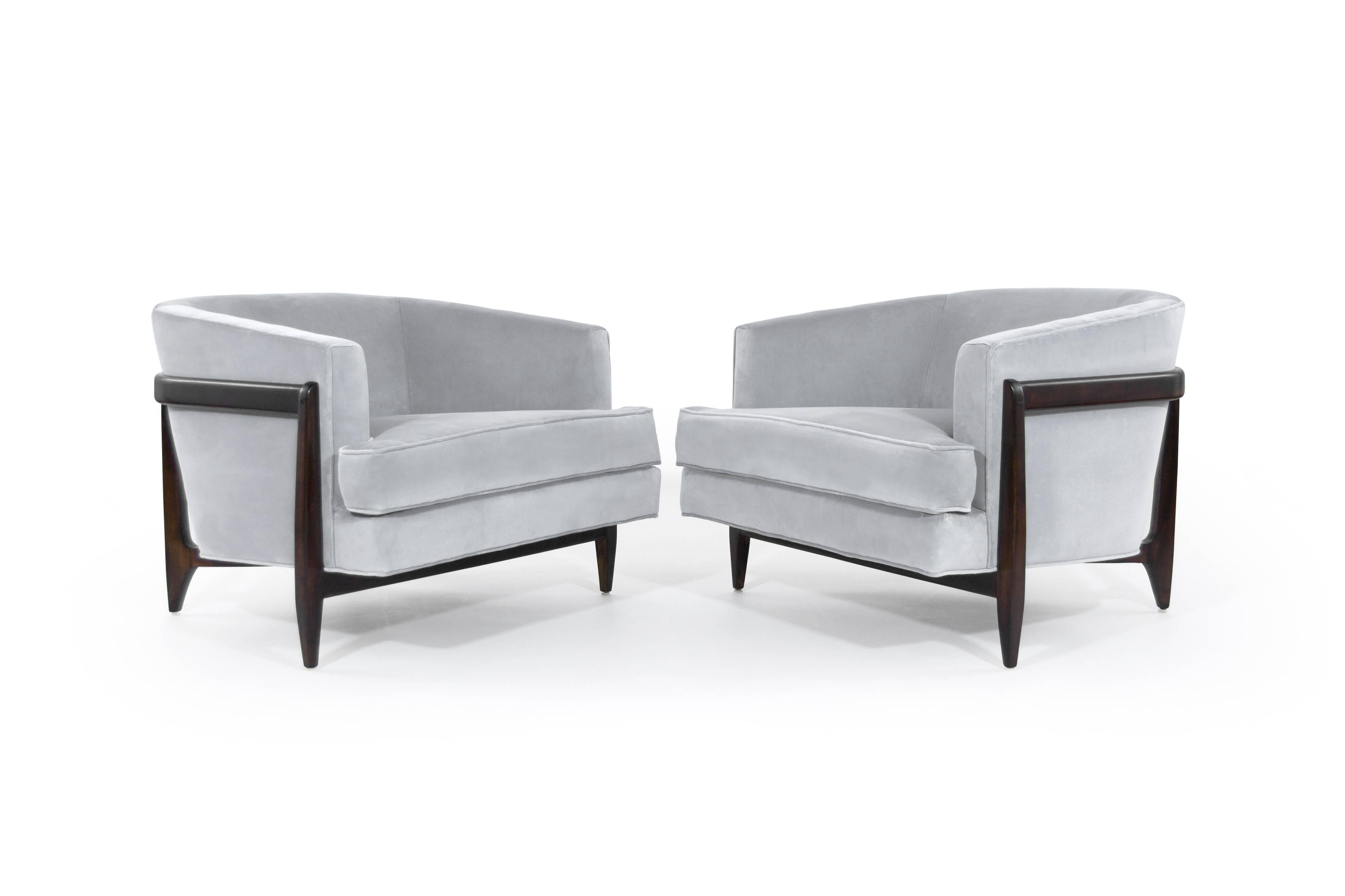 Stunning pair of lounge chairs featuring fully restored sculptural walnut frames, newly upholstered in grey velvet. Low and profile, makes this pair extremely comfortable.