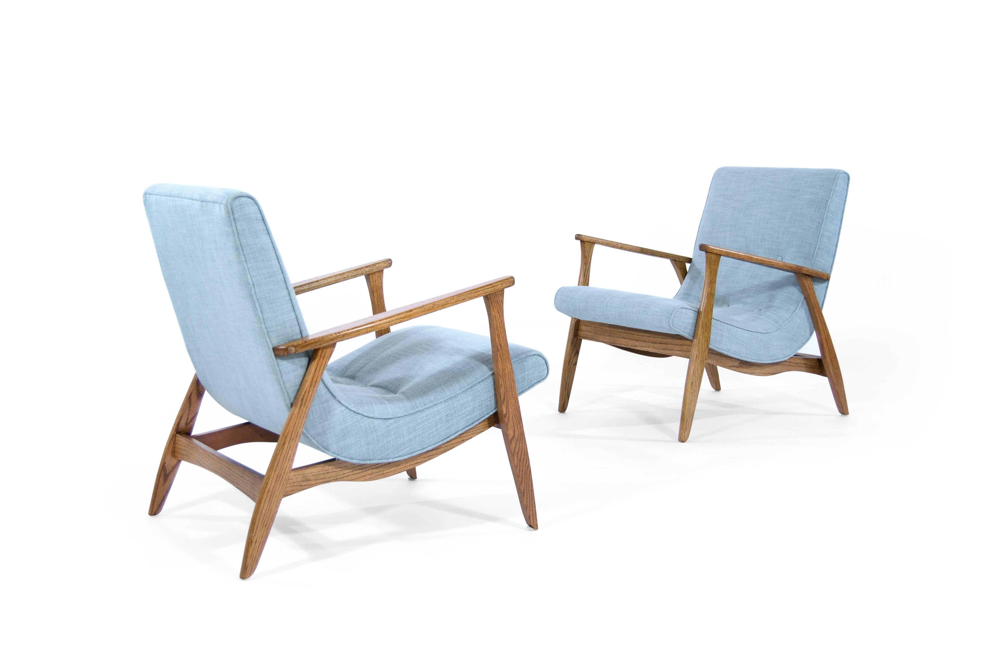 Stunning pair of lounge chairs, original from the 1960s. Oak frames fully restored and in mint condition. Newly upholstered in a very subtle light blue linen.