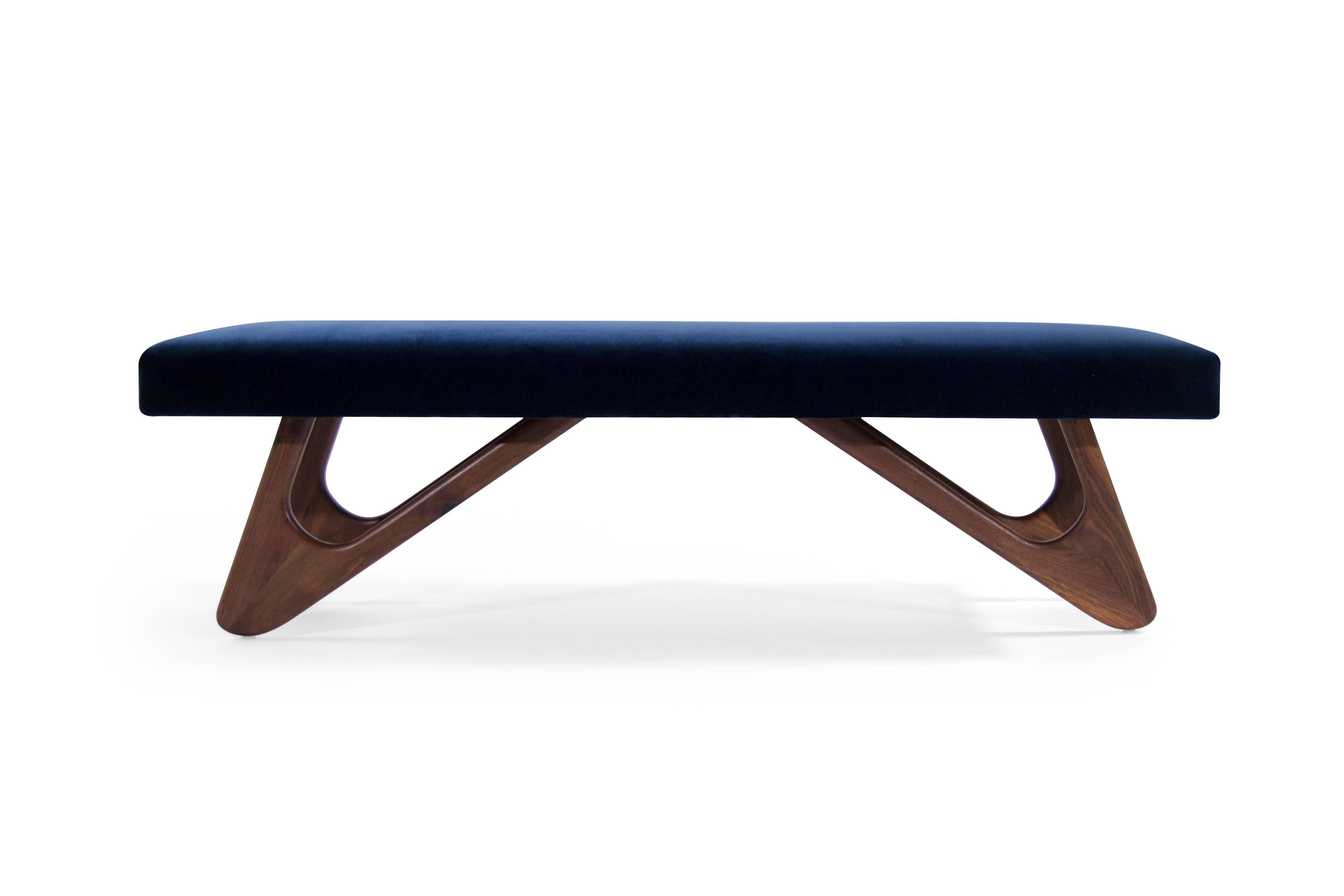 Phenomenal bench by Adrian Pearsall newly recovered in navy blue velvet. Boomerang shaped walnut legs have been fully restored.