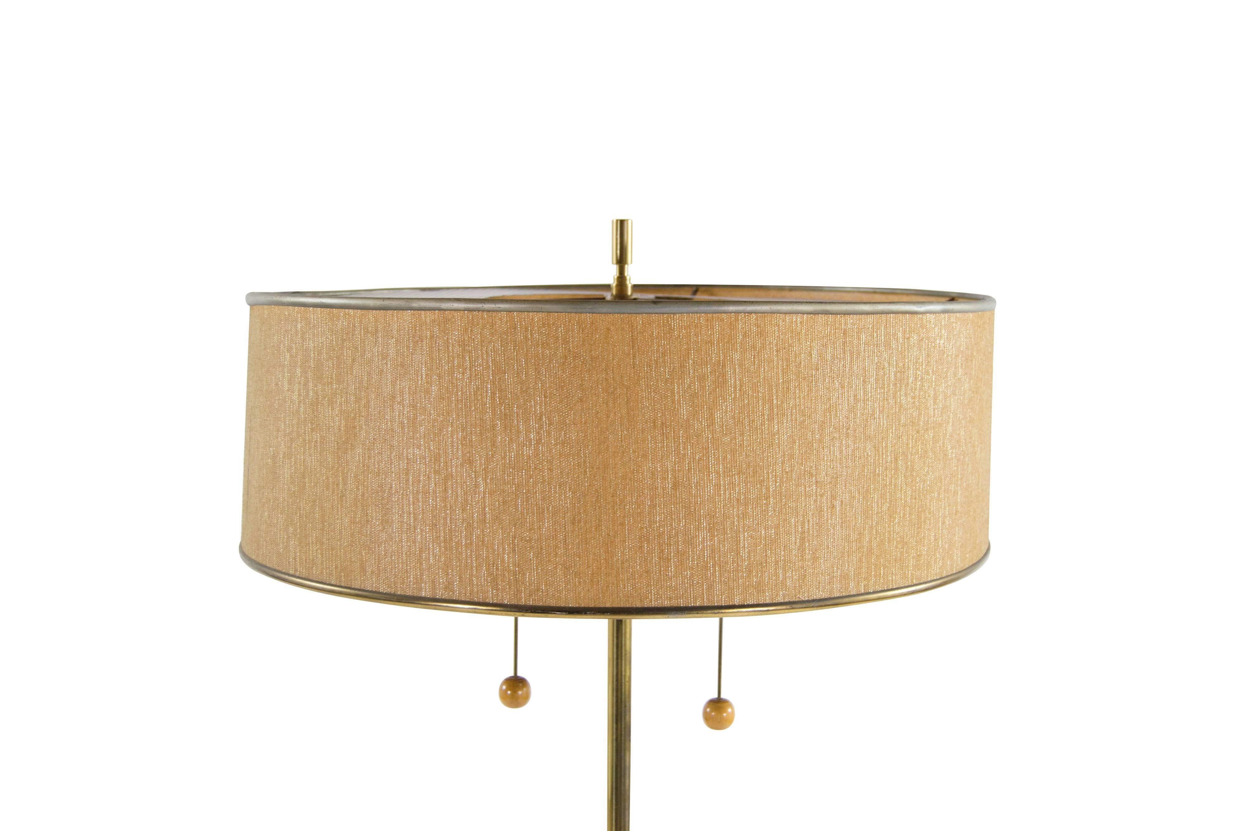Brass and walnut floor lamp with original shade designed by Gerald Thurston for Lightolier, circa 1950s. Newly rewired.